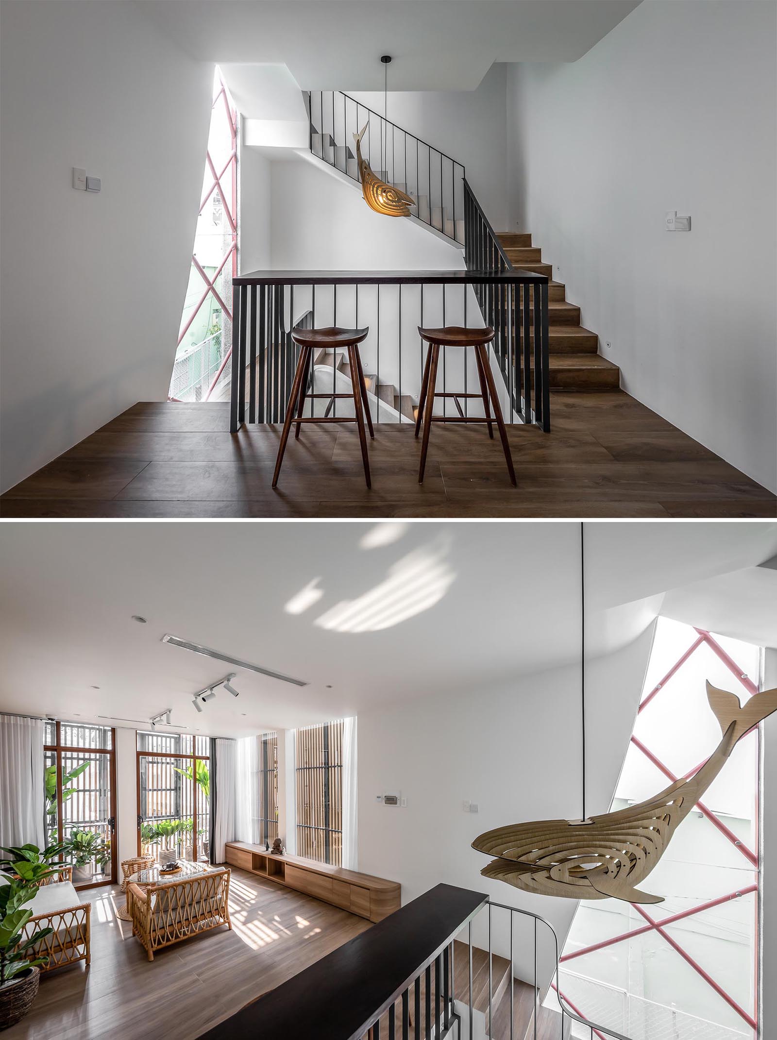 Before reaching the living room of this modern home, there's a small bar area built into the design of the black handrail. From this angle, you're able to see the wood wall sculpture light that hangs from the ceiling.