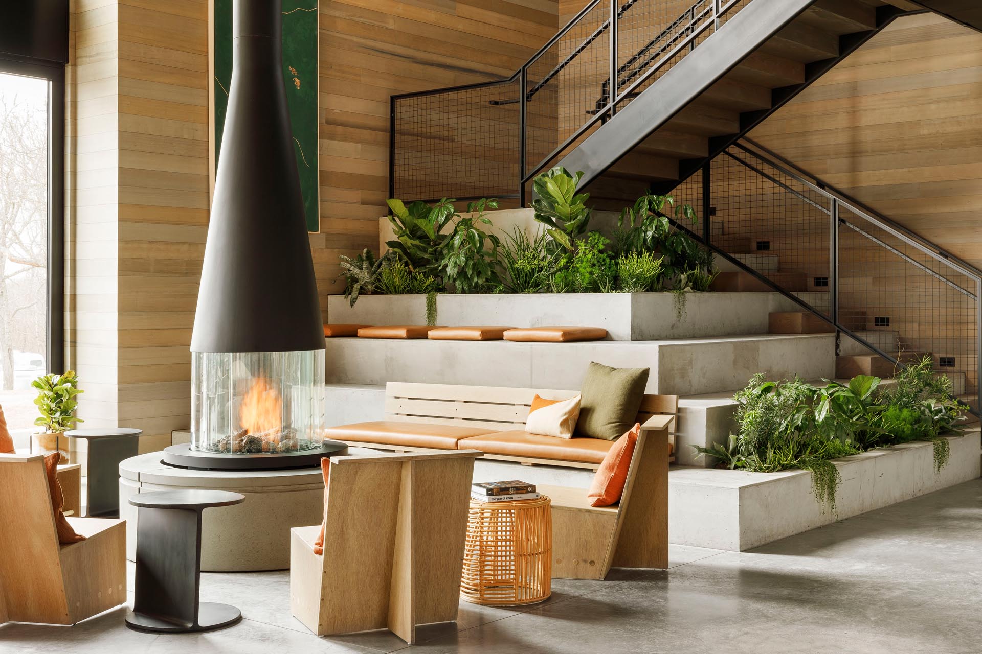 Tiered seating, created as an extension of the stairs, includes built-in planters.