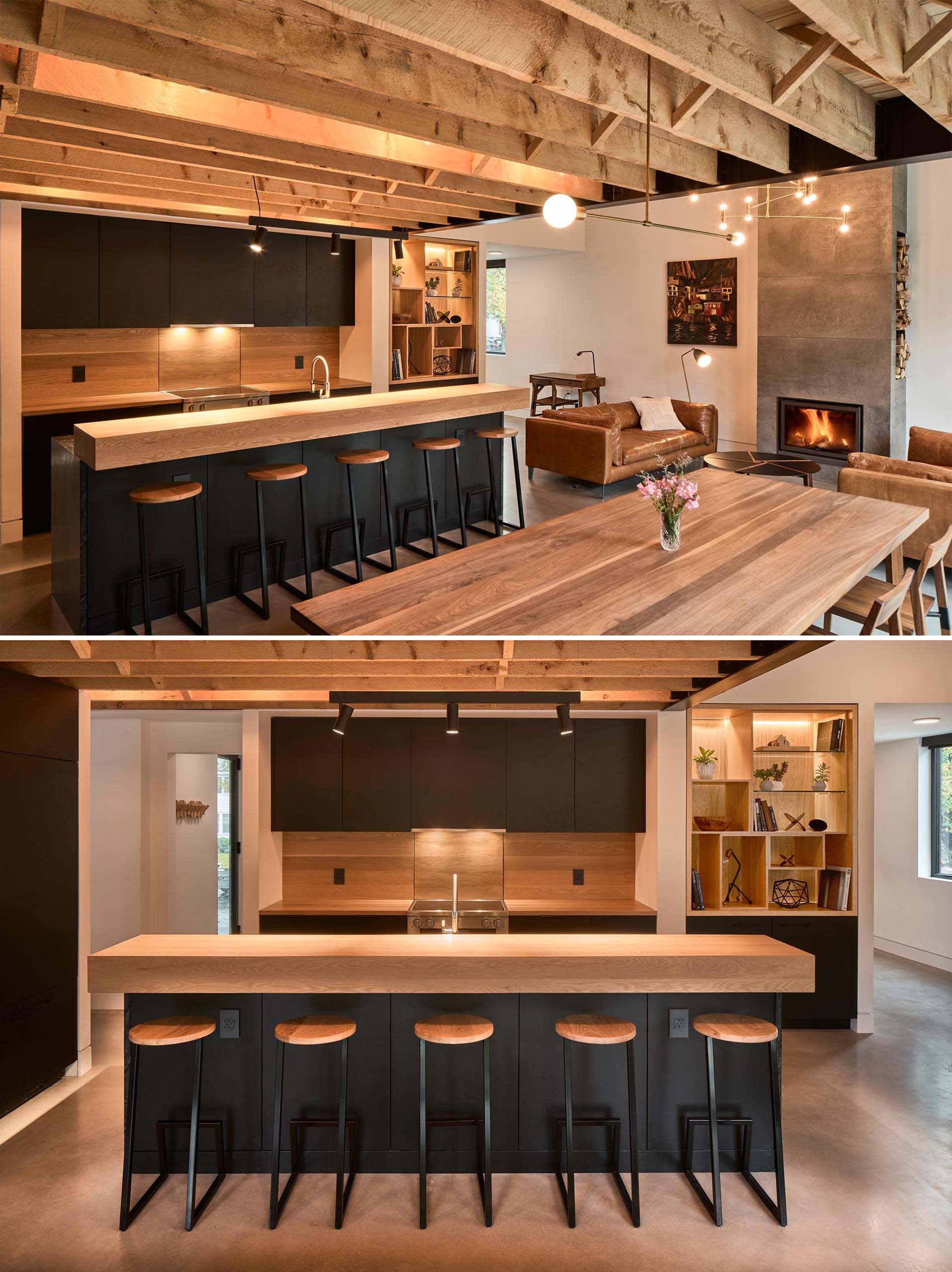 A modern open plan interior with a fireplace in the living room, a dining area, and a kitchen with matte black cabinets.