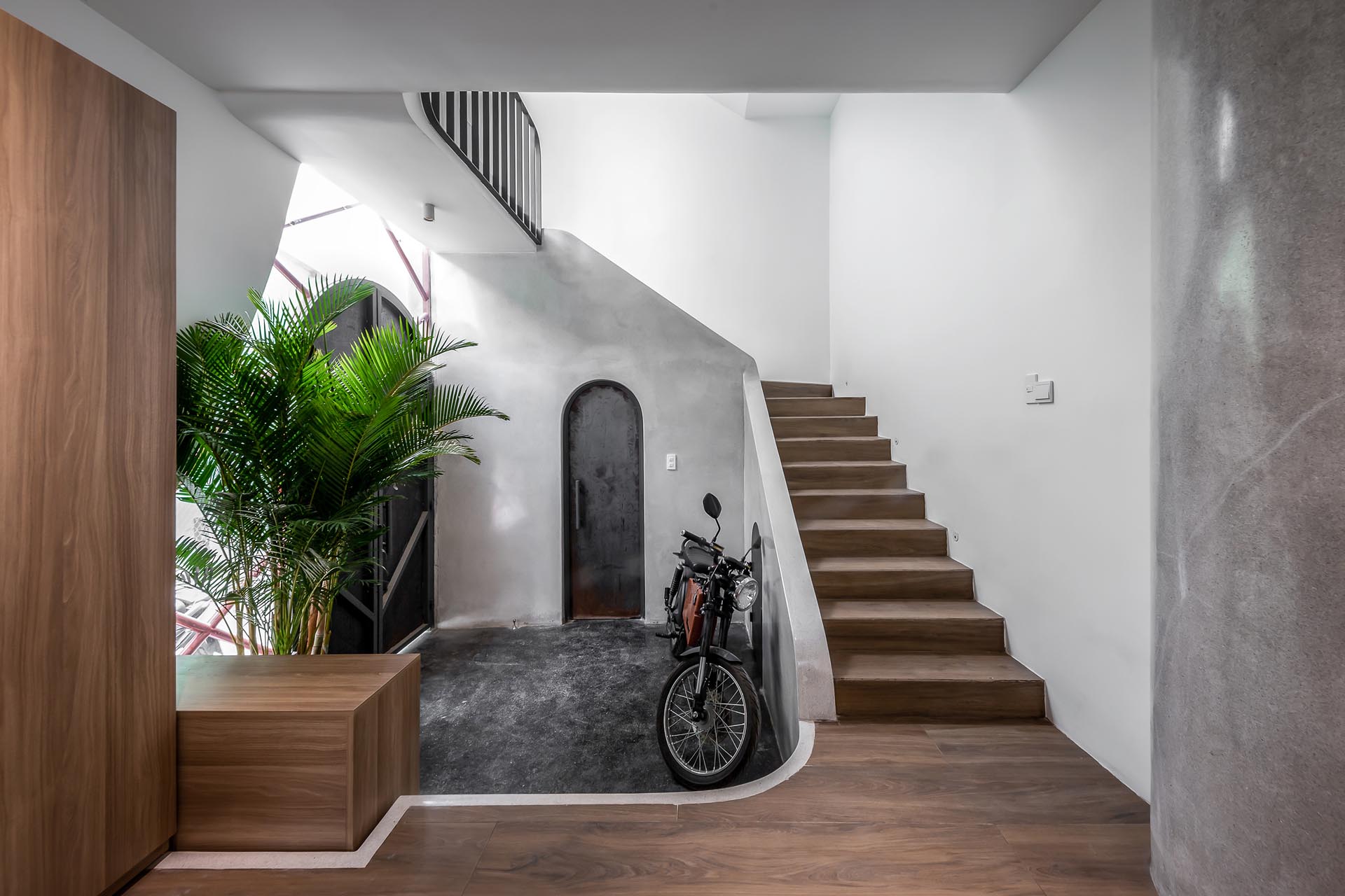 A modern home with a slightly stepped down entryway next to the stairs.