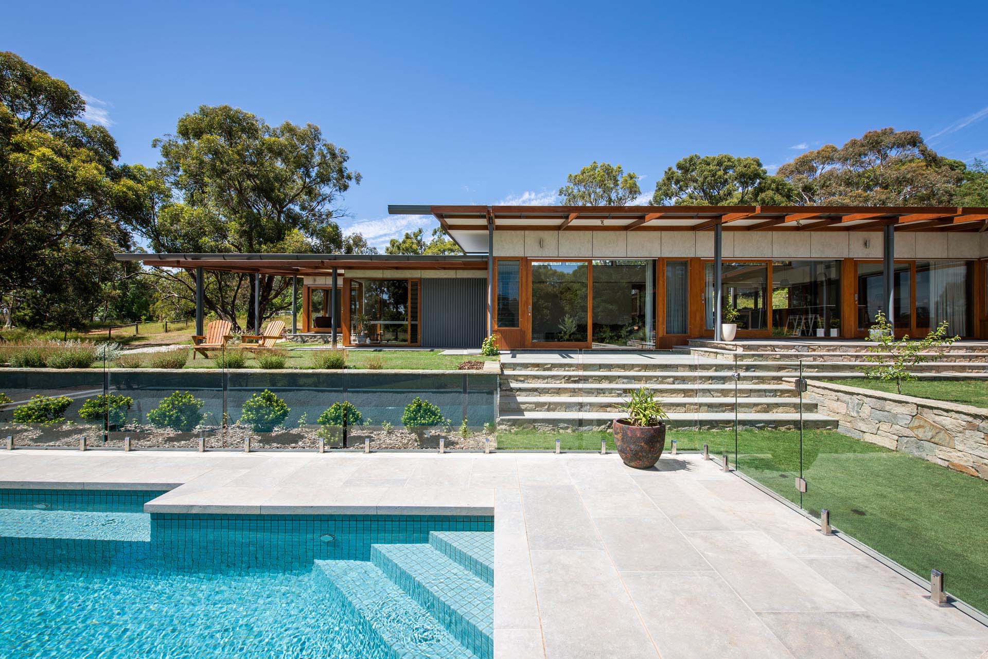 Making use of the sloped site, this modern yard has multiple levels that provide various areas for entertaining and relaxing.