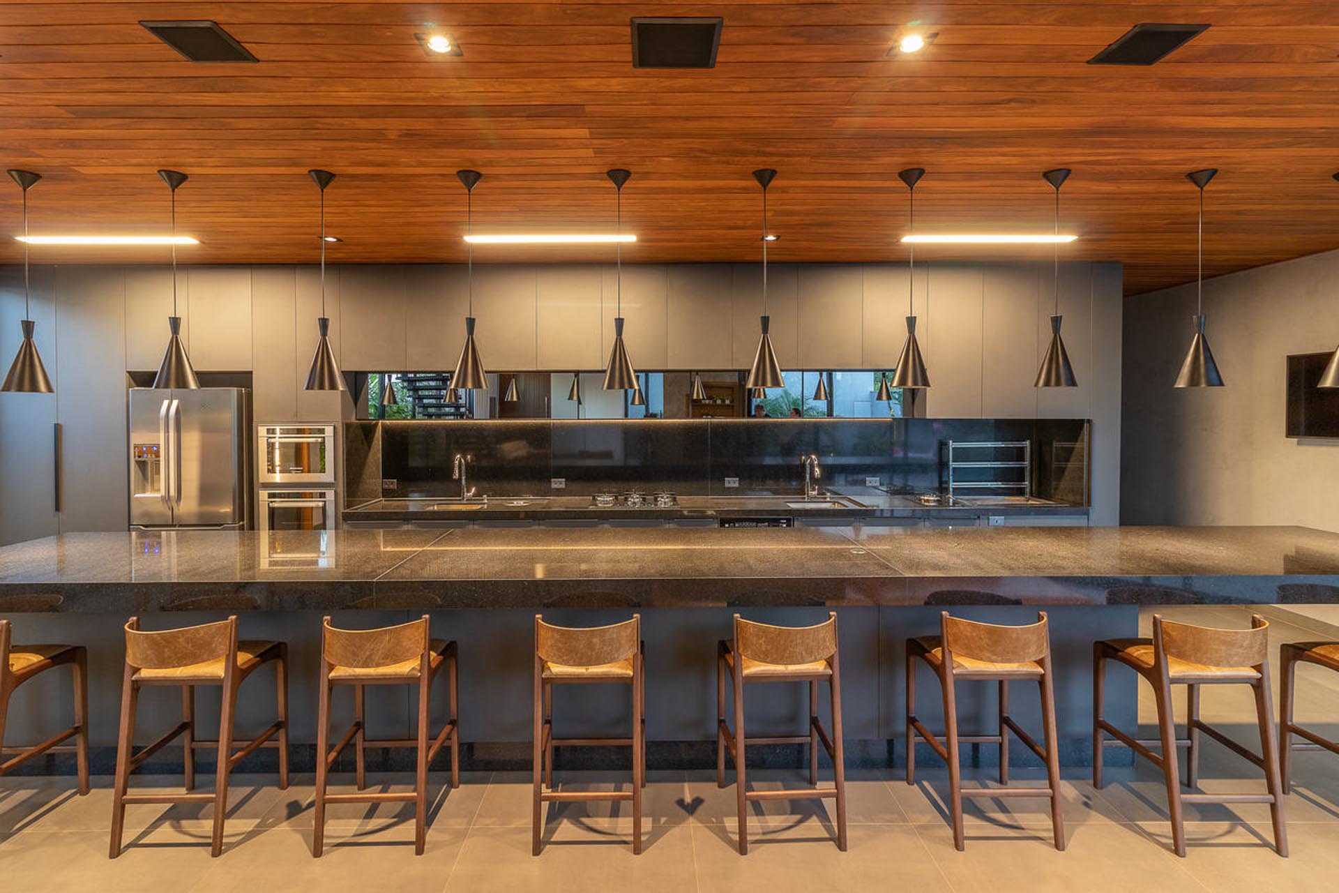 A modern kitchen with an oversized island with room for 8 people to sit at.