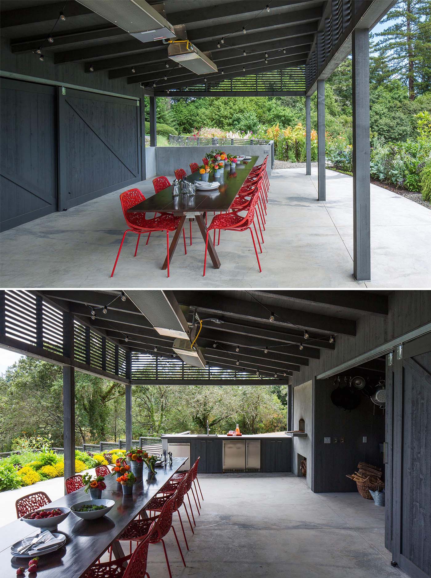 An outdoor pavilion includes dining area, a kitchen area with fridges, a pizza oven and firewood storage, as well as a separate space for storing garden items. This small room can be hidden from view by the large sliding barn doors.