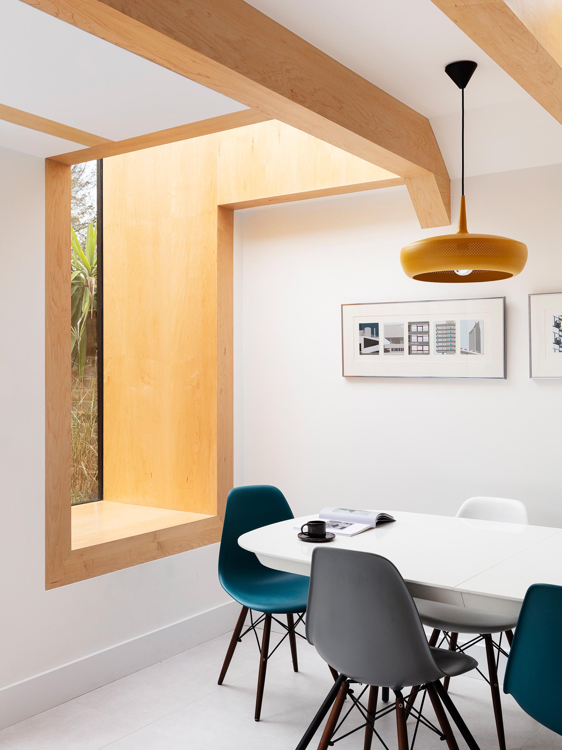 A deep set window seat lined with the same Oak wood as the beams,  has views of a fish pond.