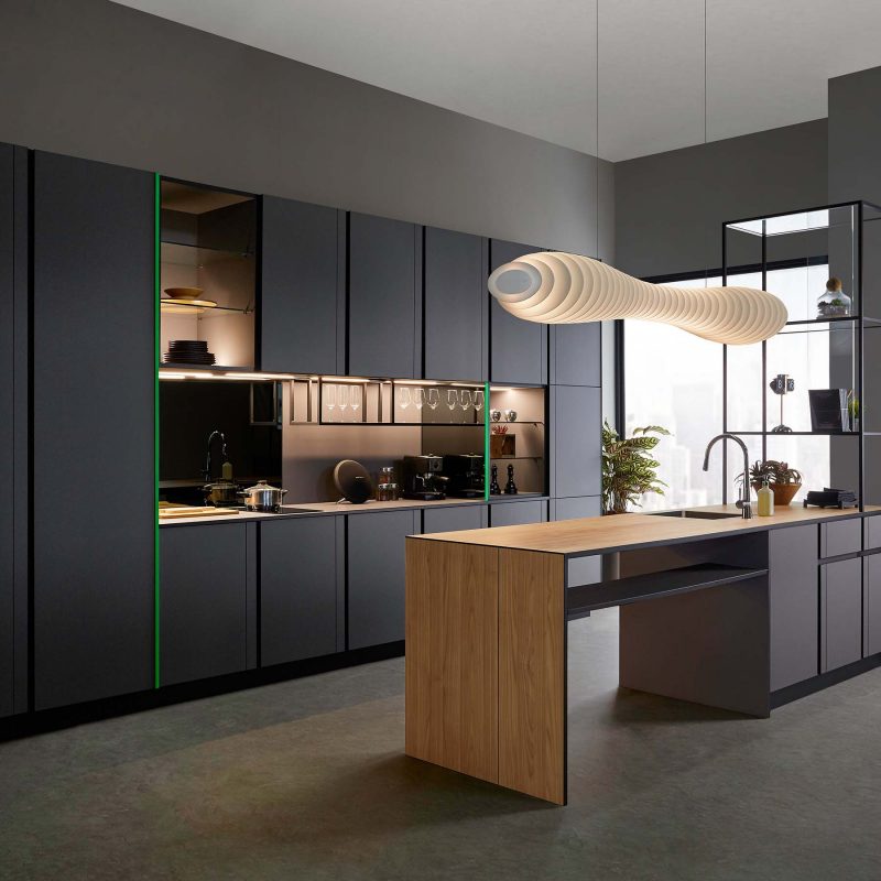 Timeless kitchen opens up to more eating, prepping, cooking and entertaining space than imaginable, with the kitchen island in the foreground while showcasing a clean, modern wall of cabinetry with a minimalistic pantry, enclosed storage and open shelving in the background.