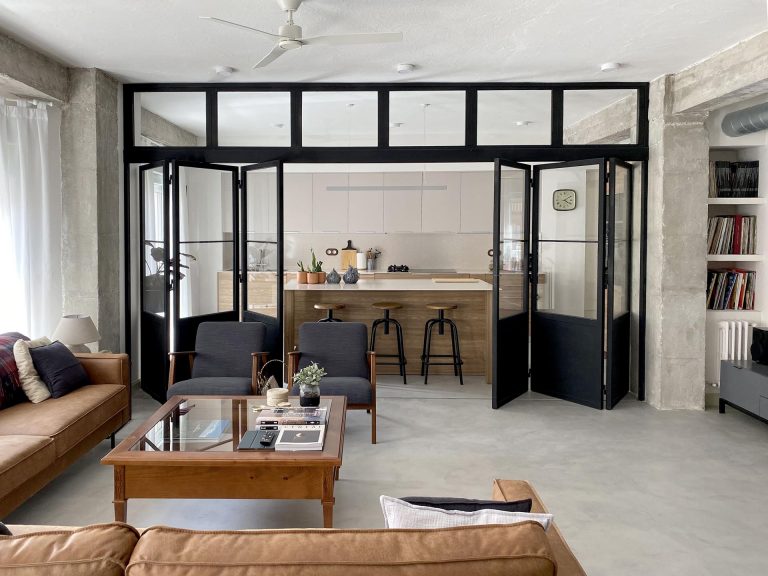 Black-Framed Doors With Windows Enclose The Kitchen But Not The Natural Light