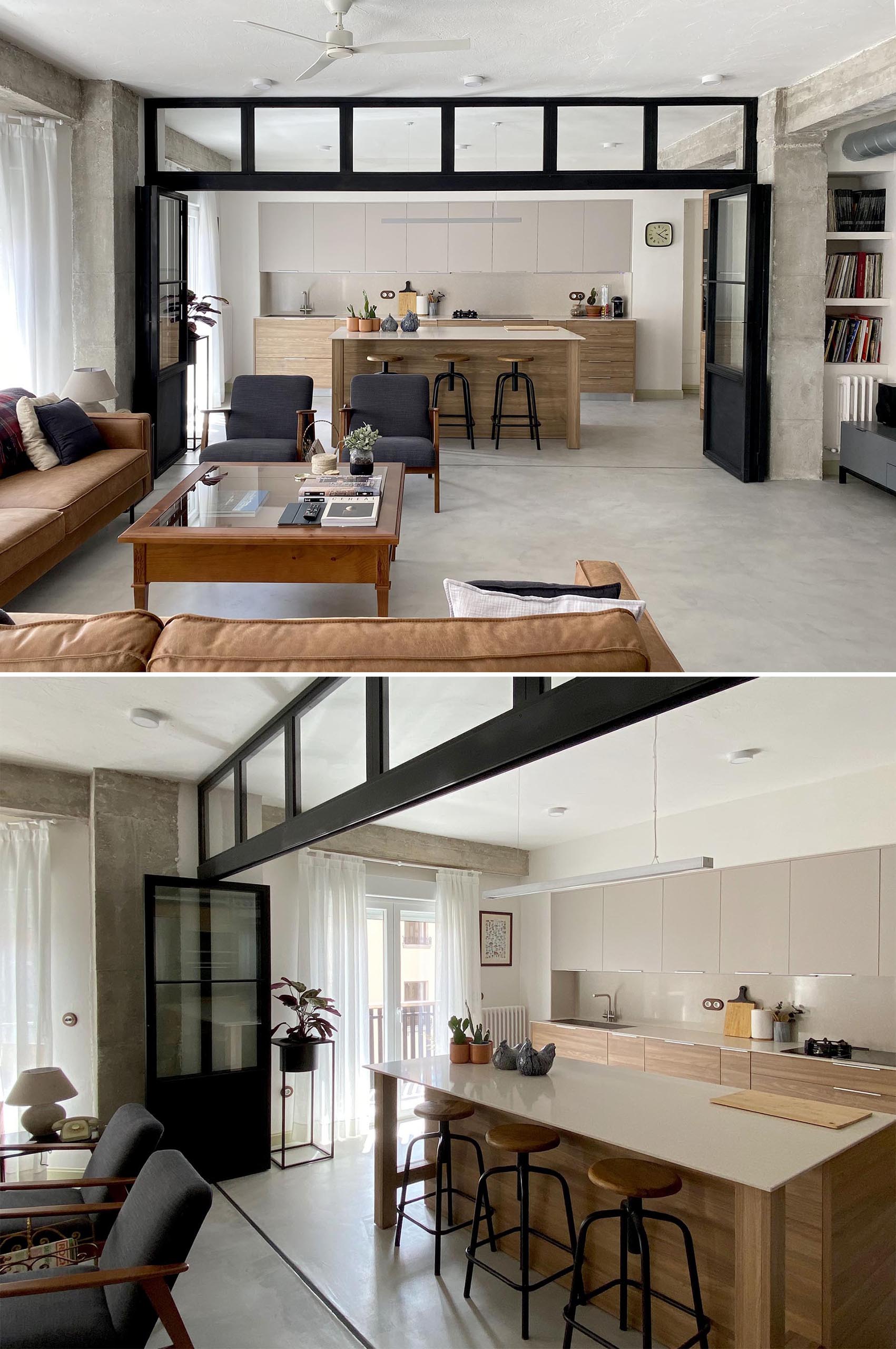 The folding black-framed glass doors sit below a row of windows, and when open or closed, the doors allow the natural light from the windows in the the exterior wall to travel throughout the interior. 