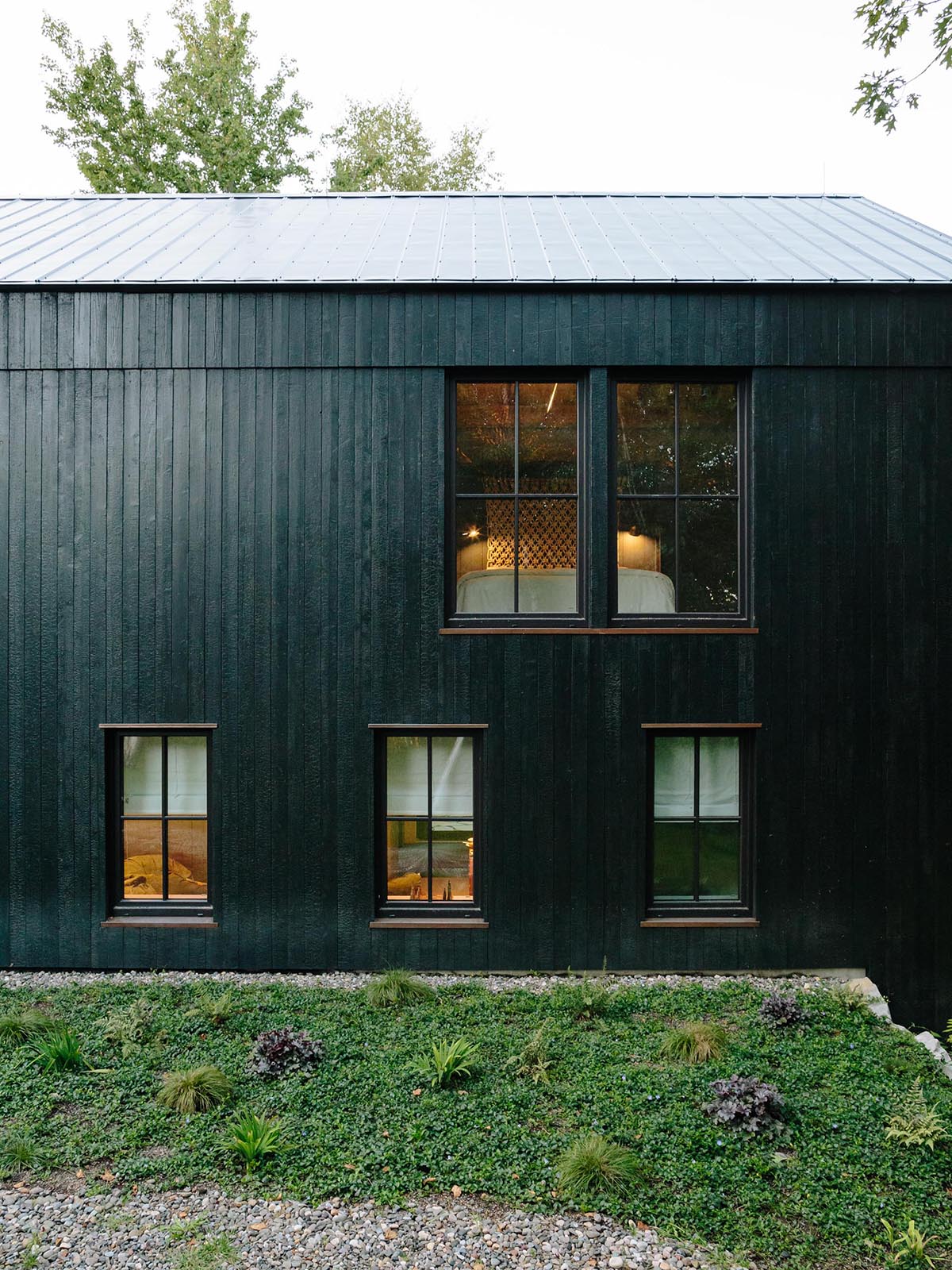 A large cabin-style home with charred cedar siding.