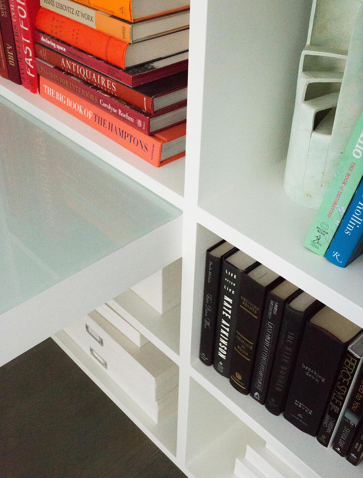 A contemporary bookshelf that meets a desk.