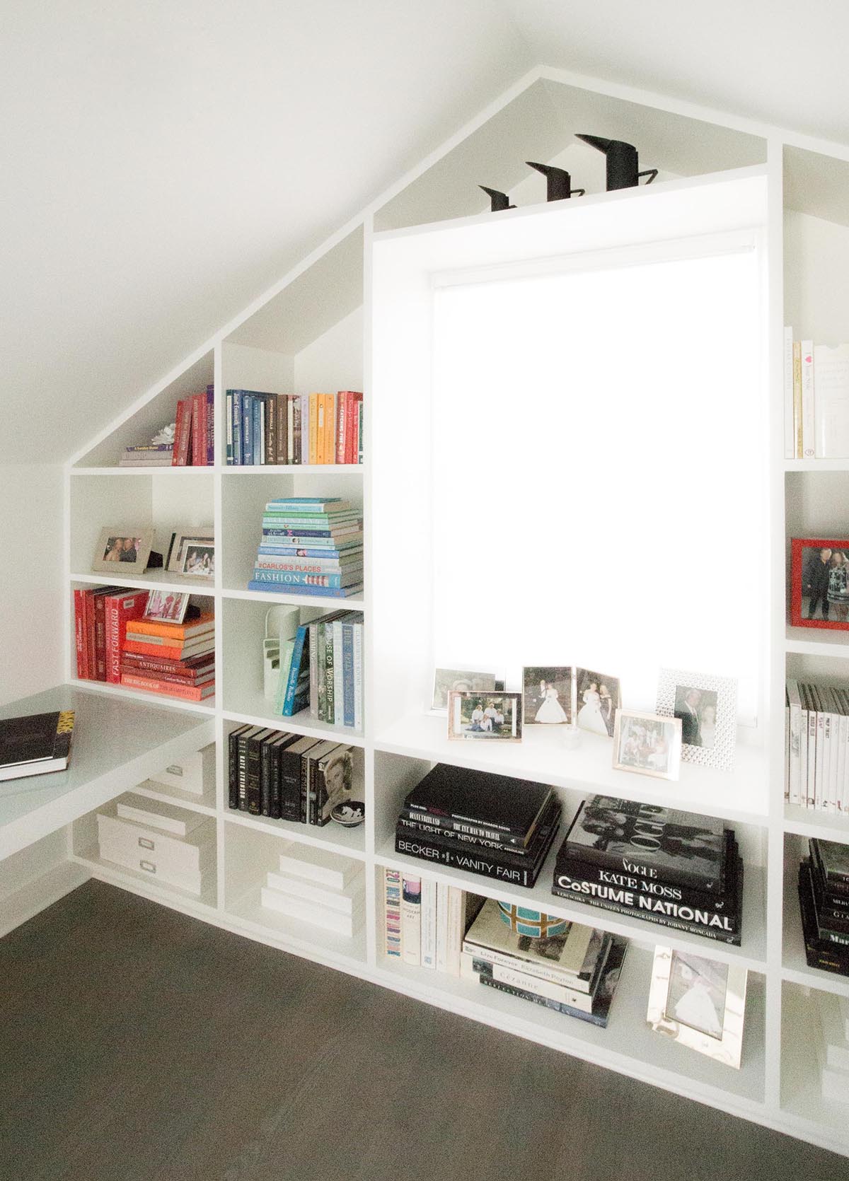 The focal point of this home office is the custom bookshelf that fills the entire wall and wraps around the window.