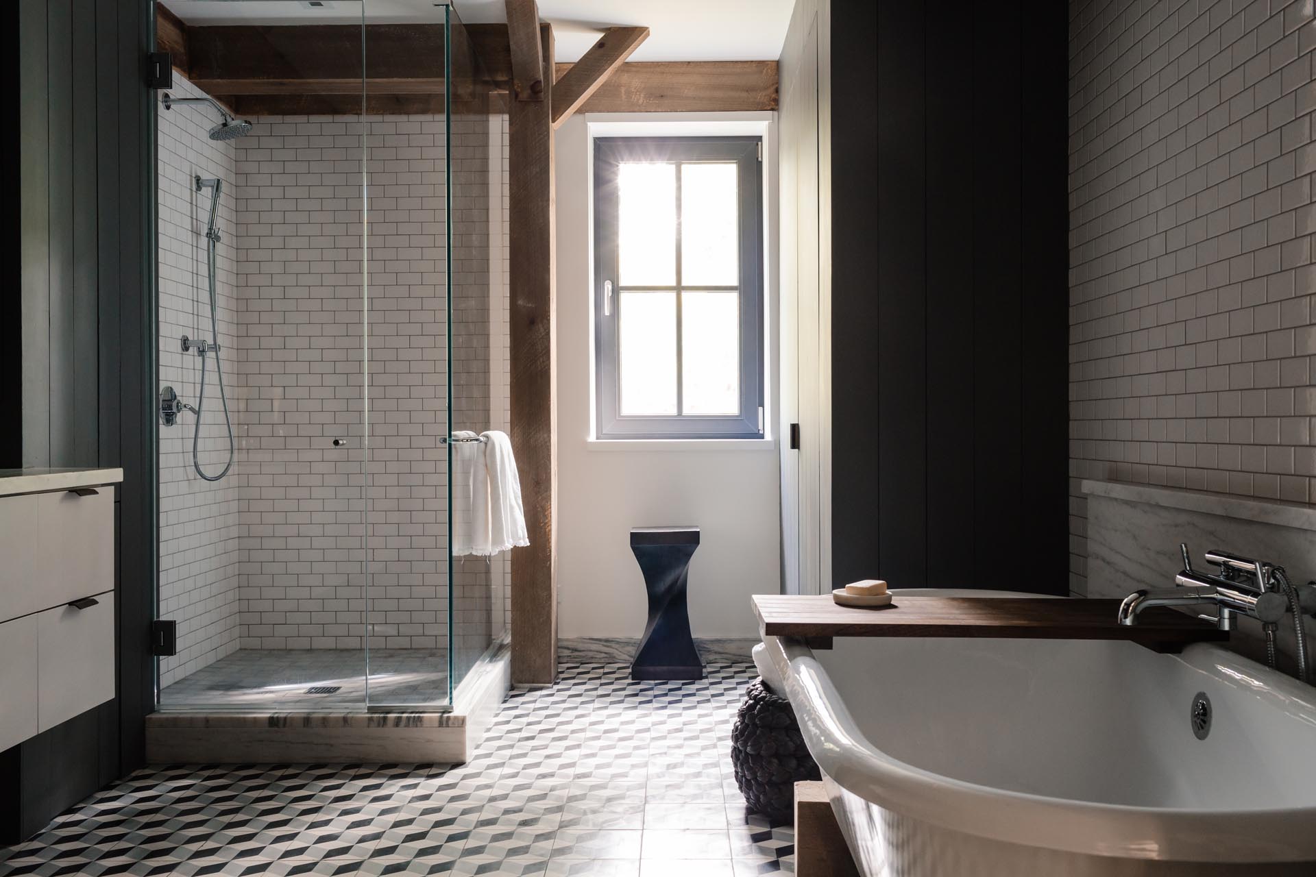 A contemporary bathroom with a glass-enclosed shower and a freestanding bathtub.