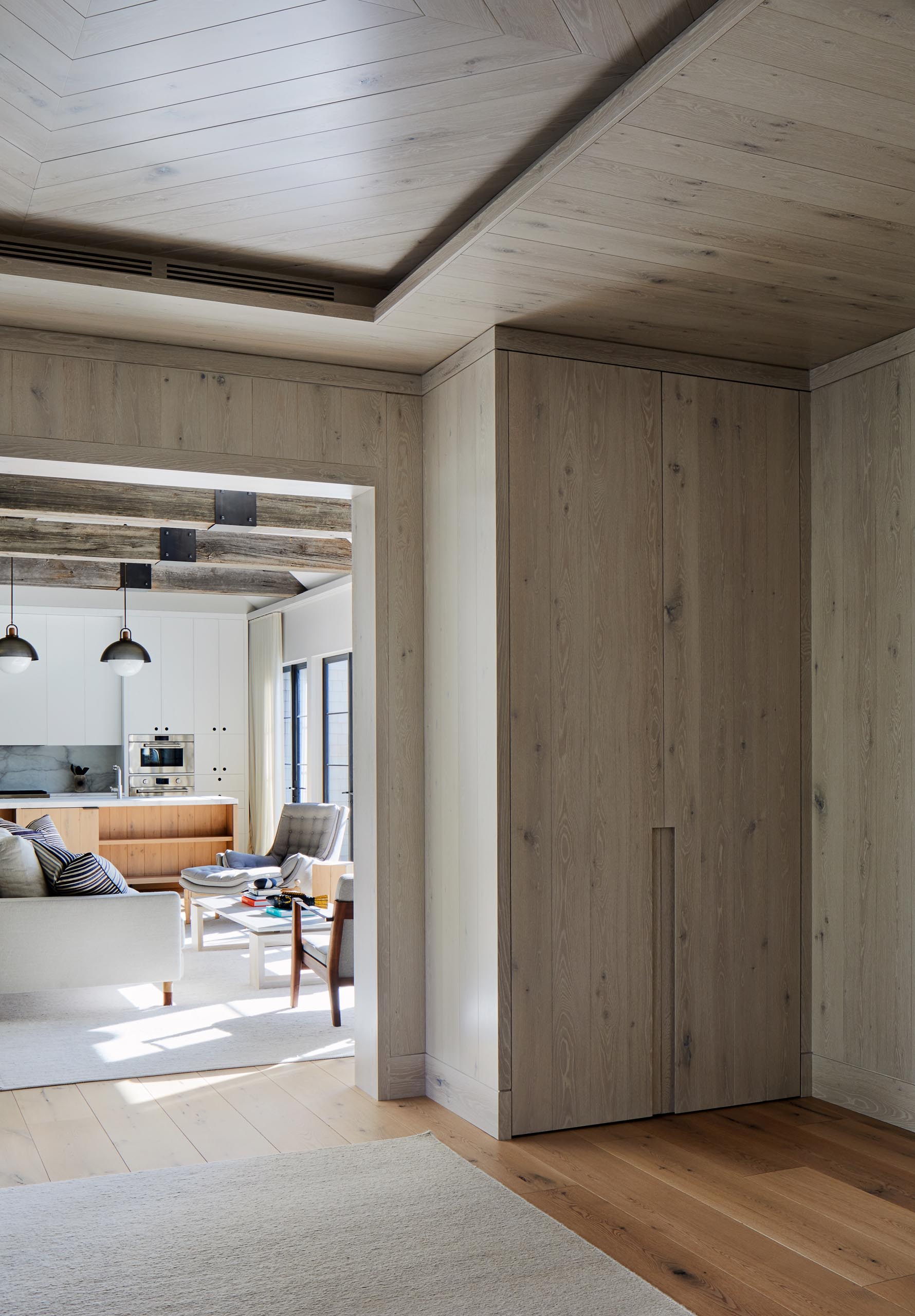 This entryway includes solid, bleached walnut storage cabinets.