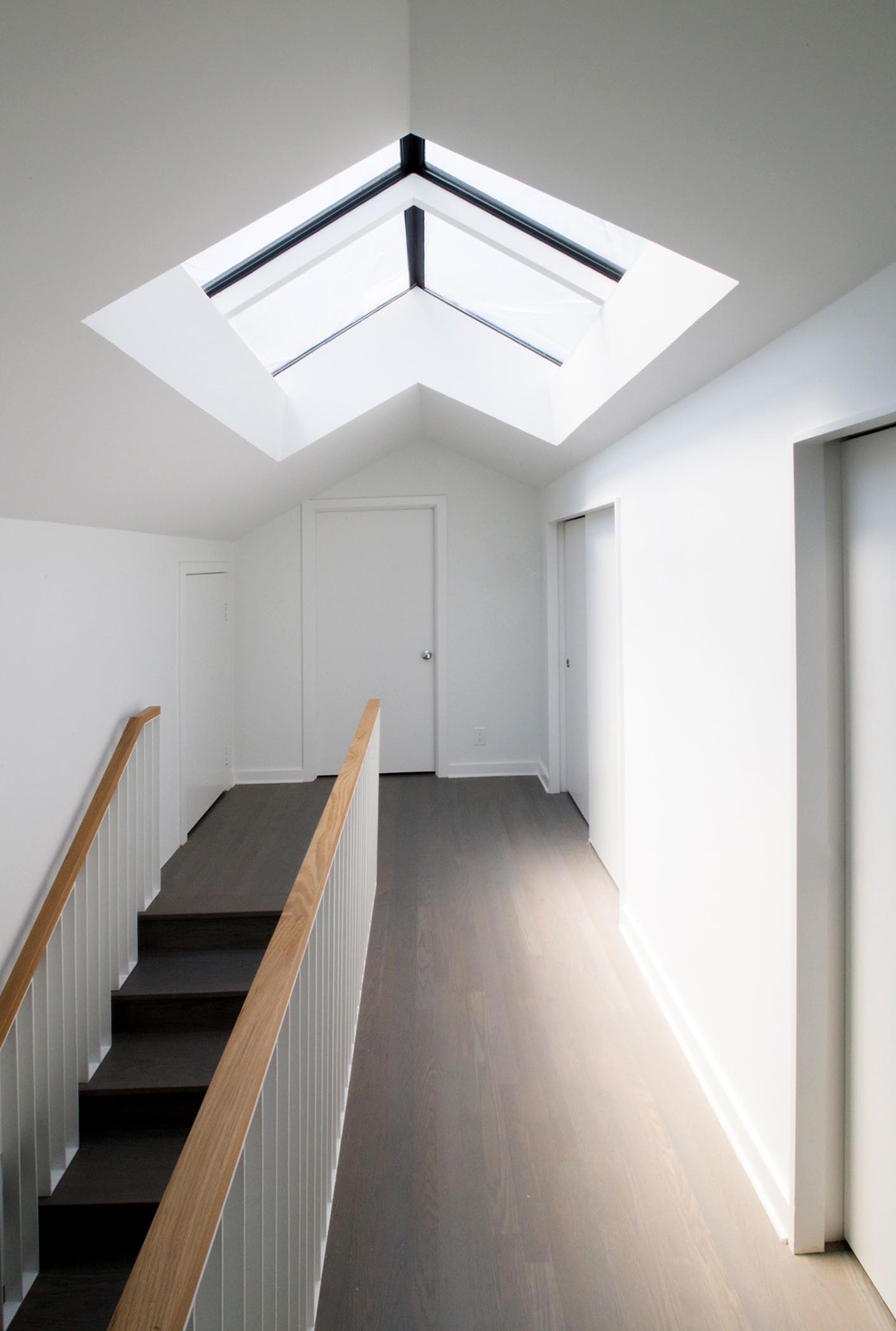 A contemporary home with a pitched ceiling and skylights.