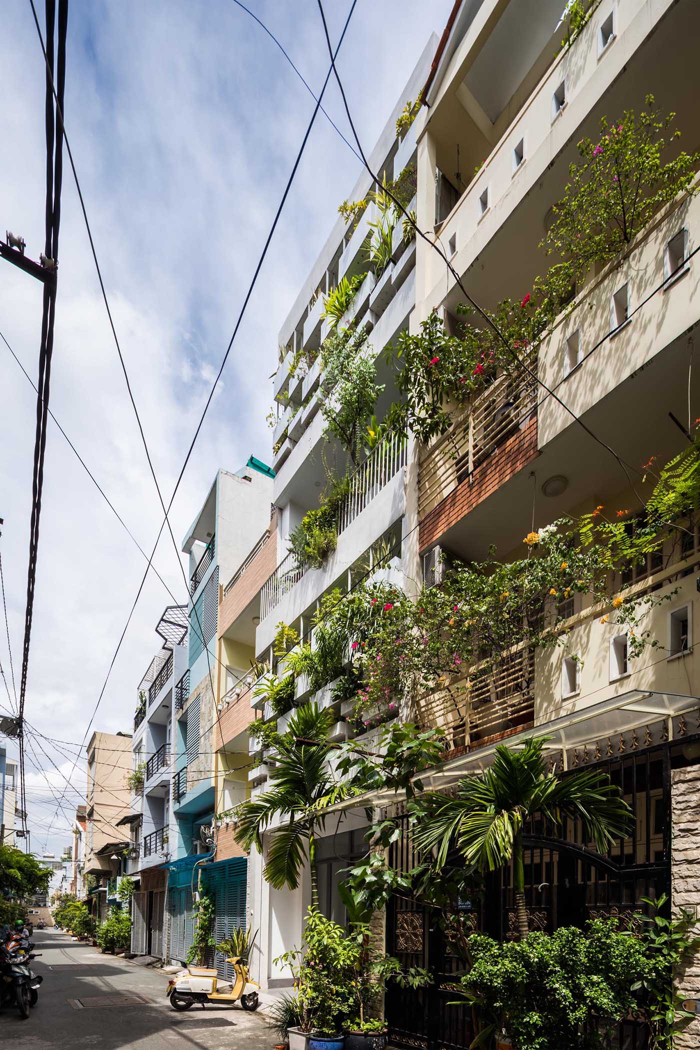 Planters have been added to the facade of this modern house, incorporating a  natural element into the concrete exterior.