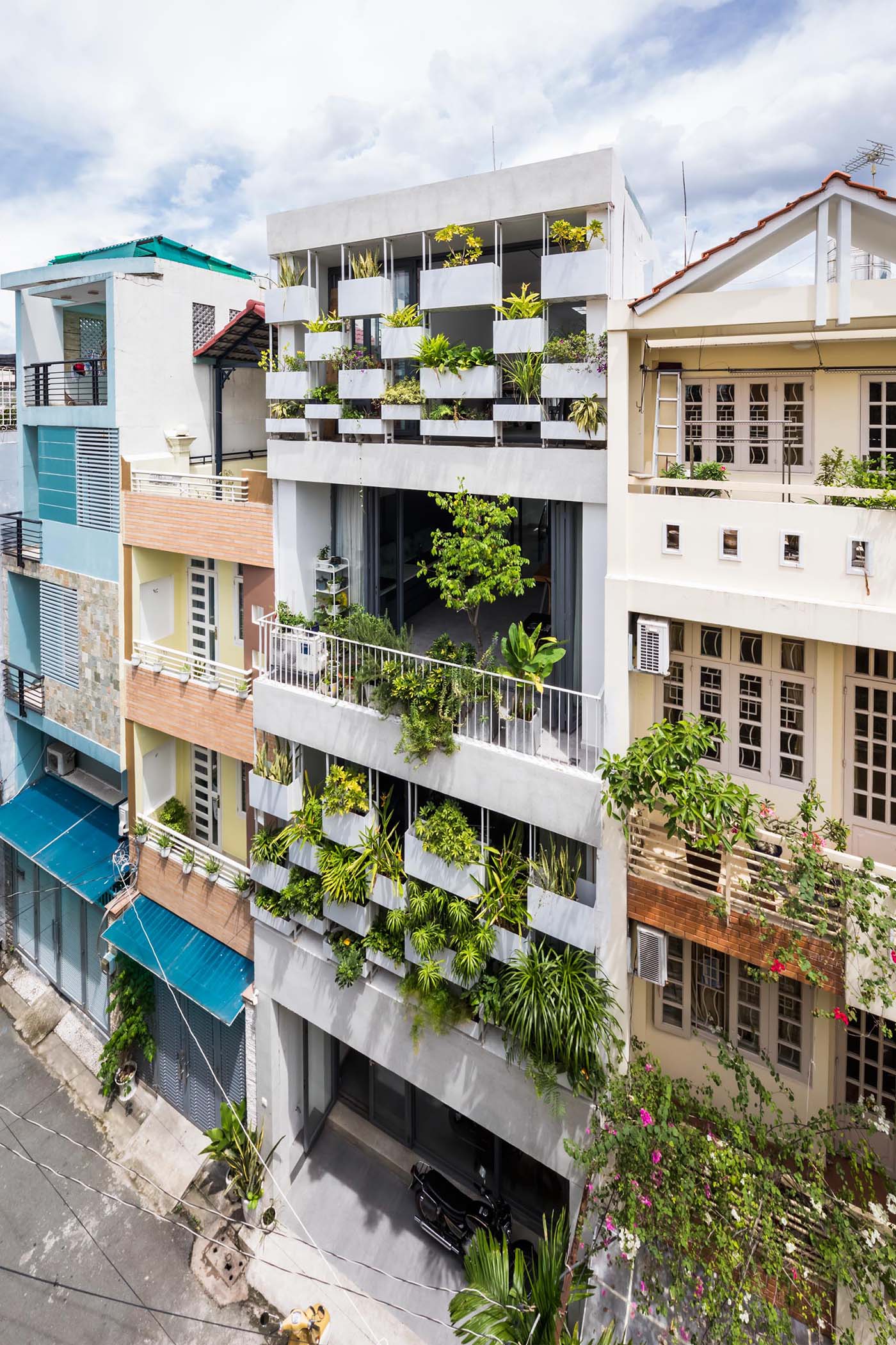 Planters have been added to the facade of this modern house, incorporating a  natural element into the concrete exterior.