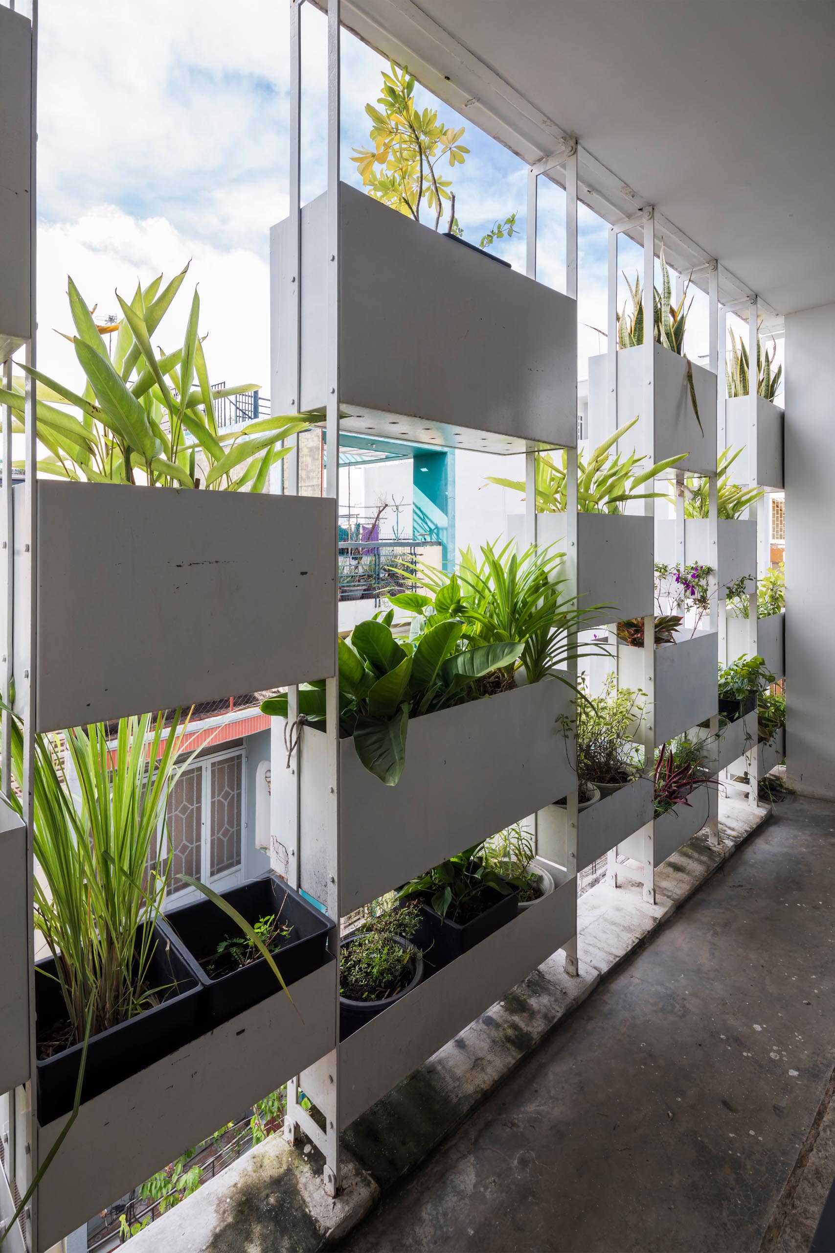 Planters have been added to the facade of this modern house, incorporating a  natural element into the concrete exterior.