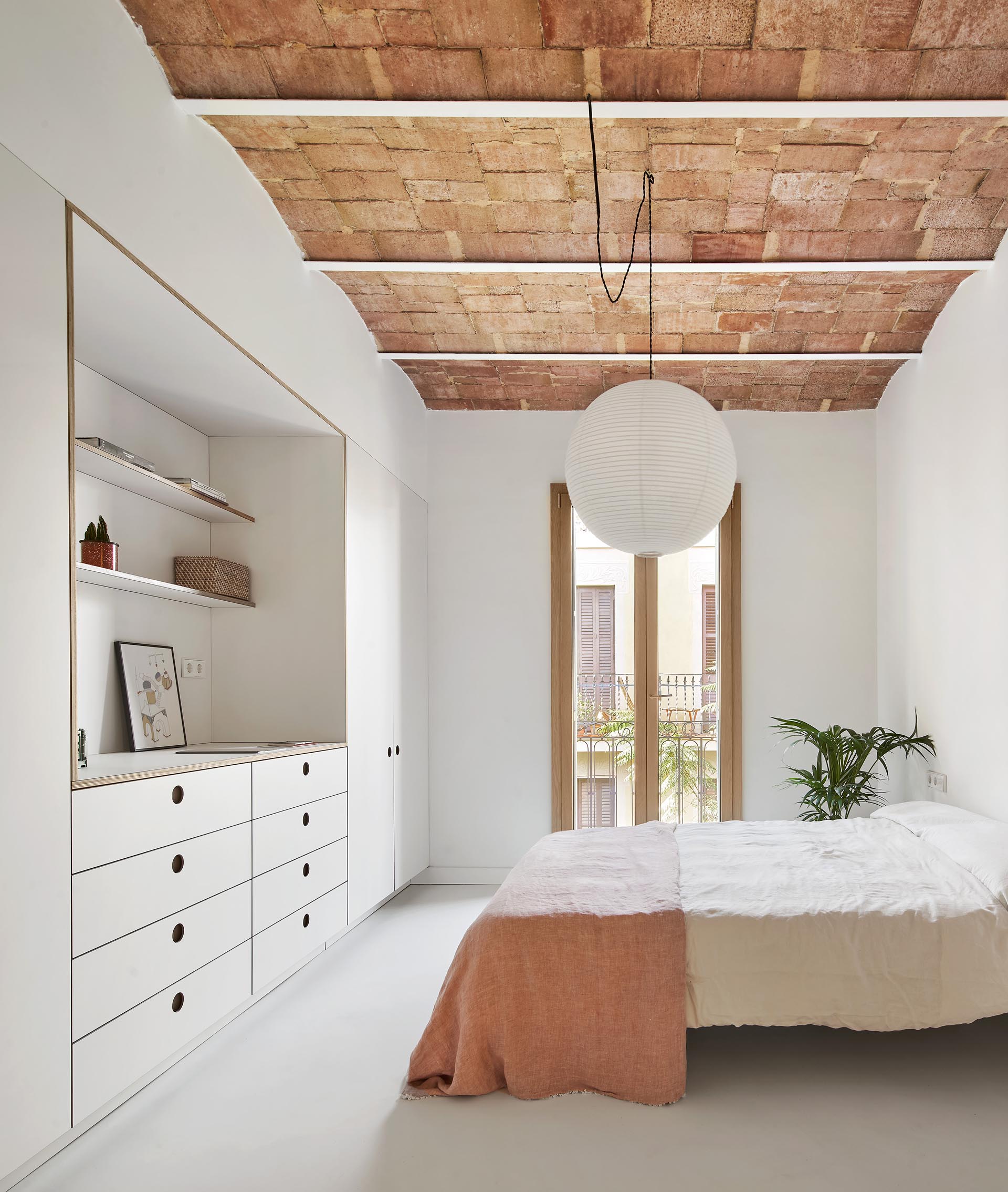 Minimalist bedroom closets and drawers with recessed finger pulls.