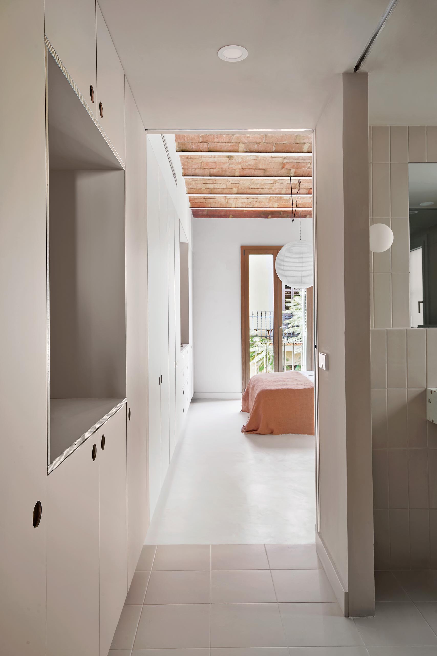 Minimalist bathroom and bedroom cabinets with recessed finger pulls.