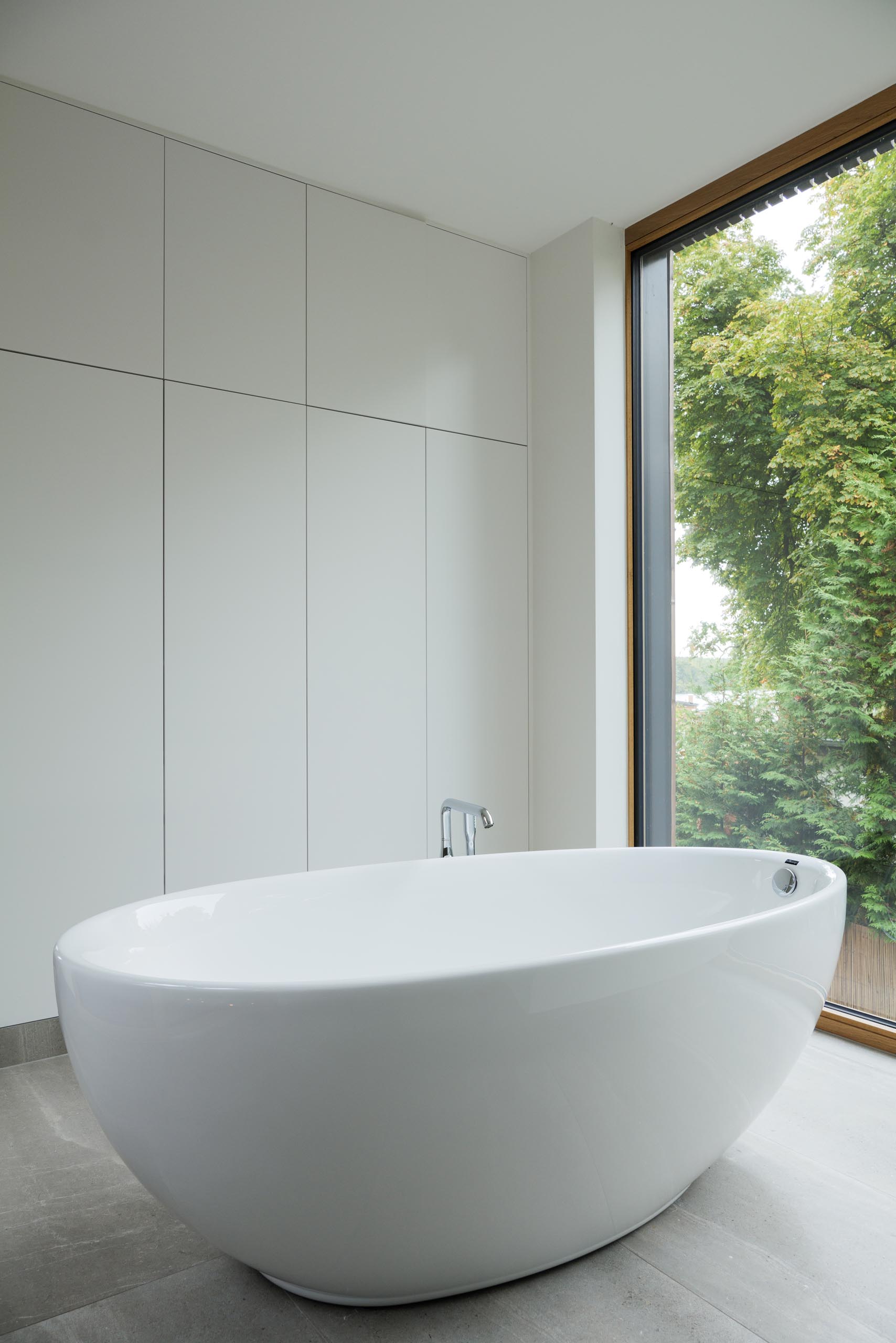 A white bathroom with a freestanding bathtub.