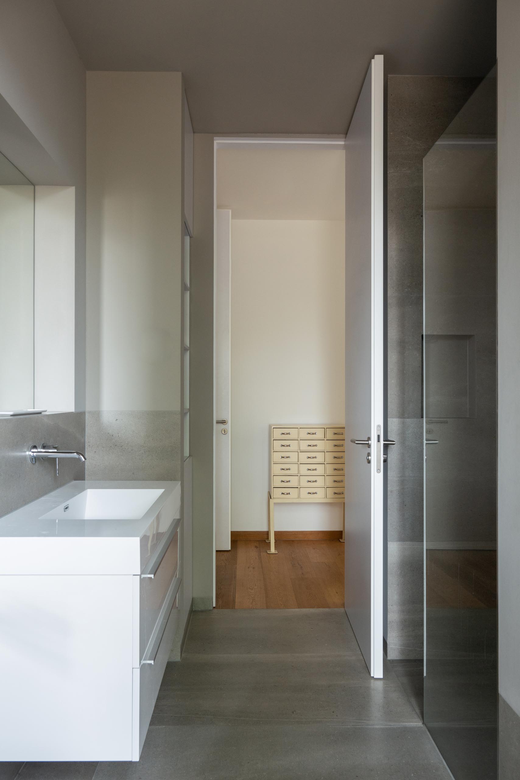 A modern bathroom with a white vanity.