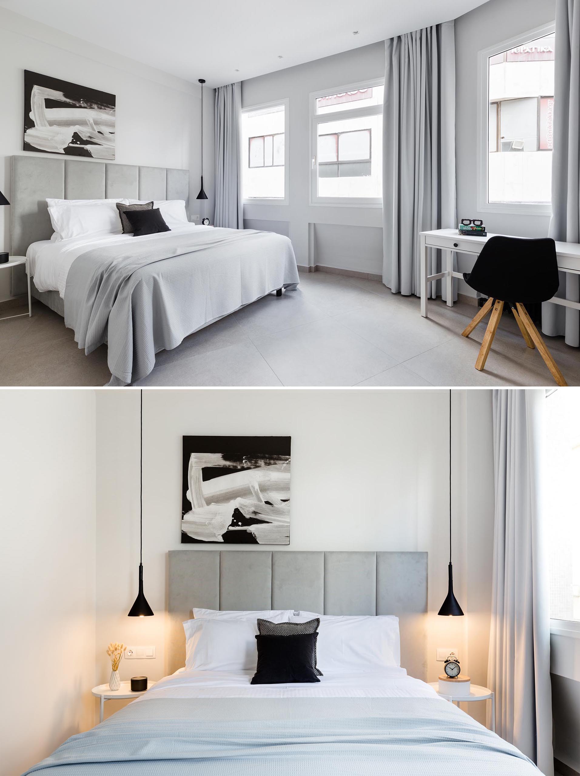 A modern bedroom where the color palette is filled with grays, black and white. At night, the pendant lights beside the bed add a warm glow.