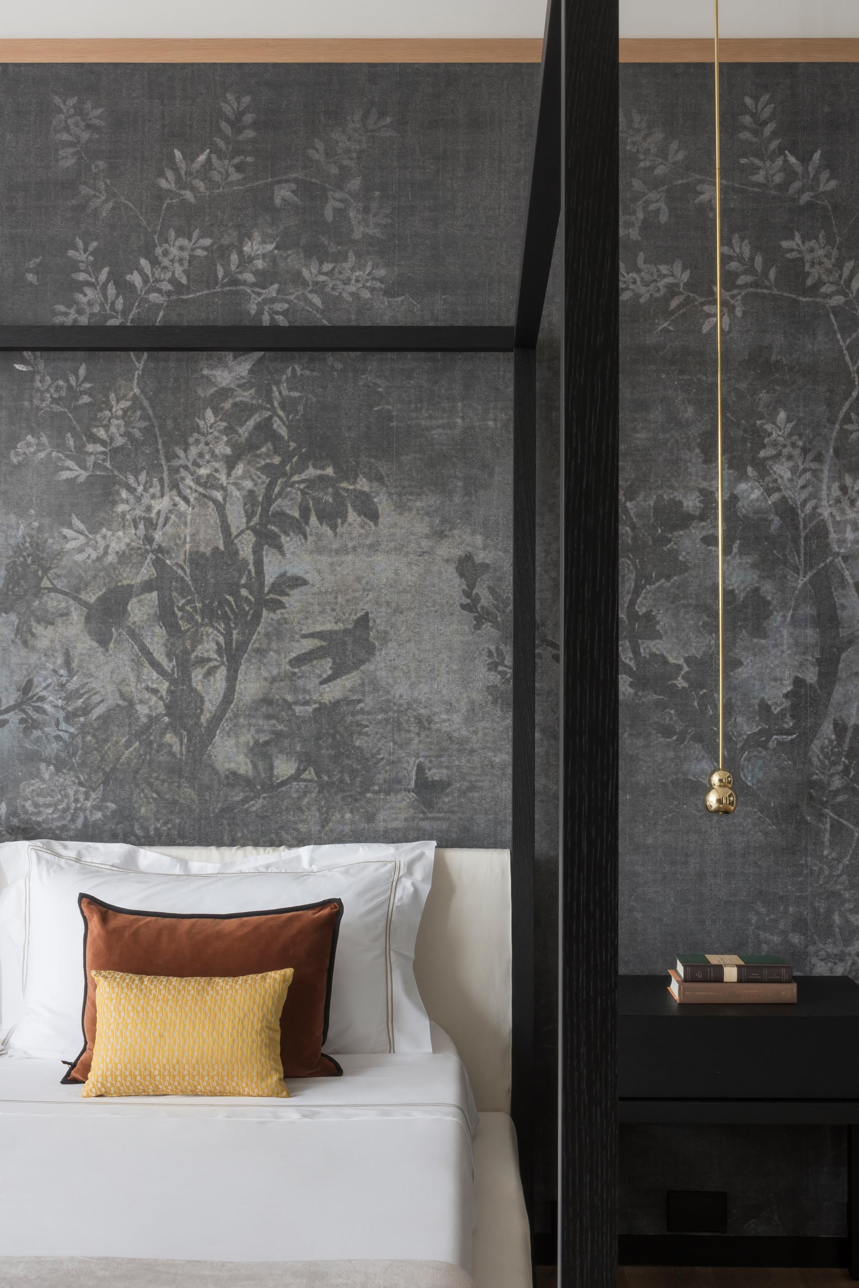 A modern bedroom with a wallpaper that features a floral print.