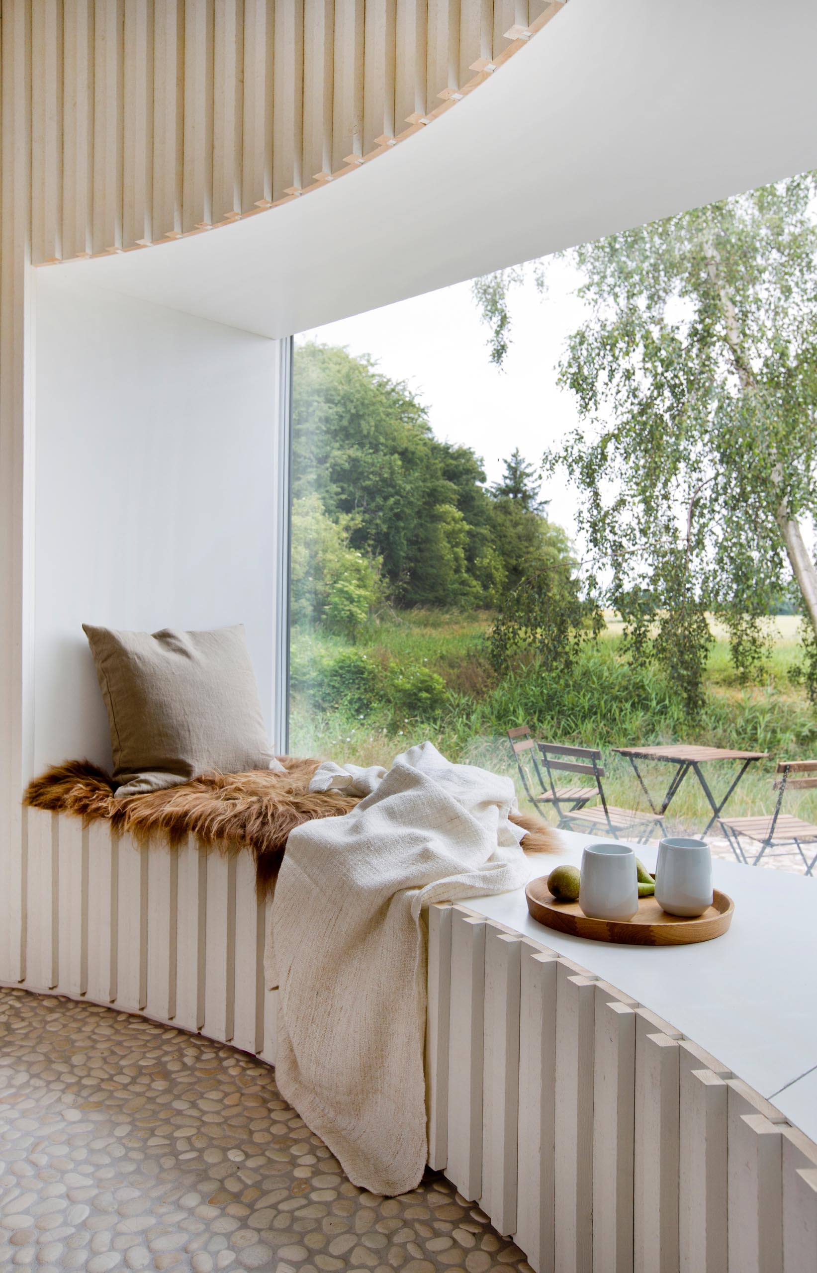 A modern and expansive curved window seat.