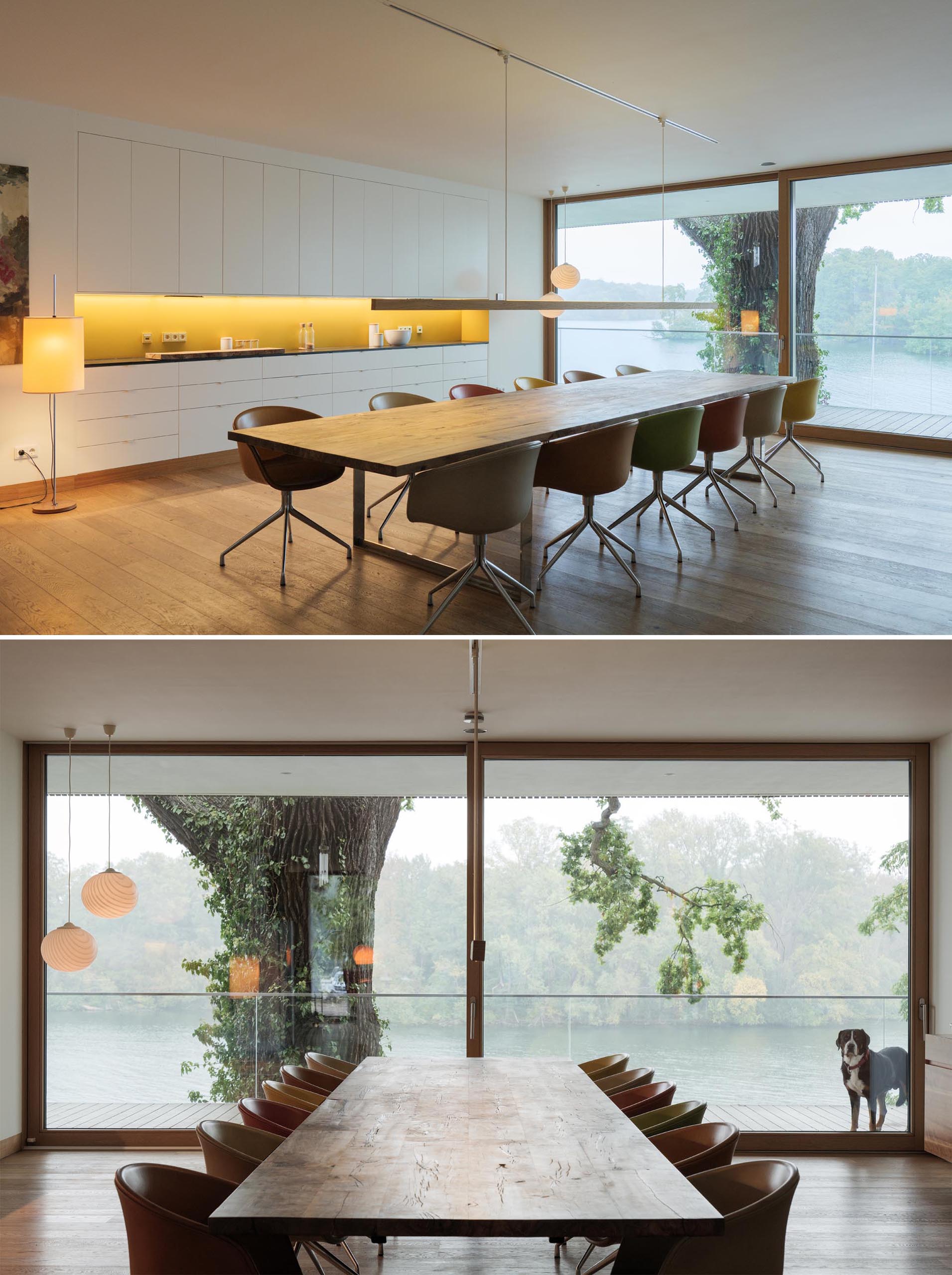A modern dining room with an oversized wood table, matching minimalist pendant light, and colorful artwork.
