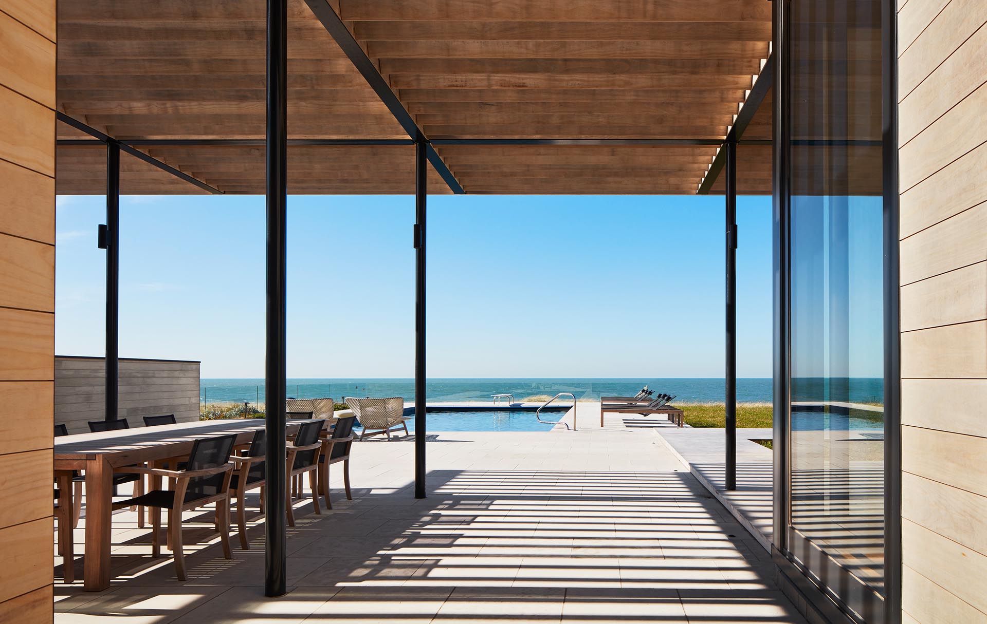 A modern home with a covered patio and outdoor kitchen.