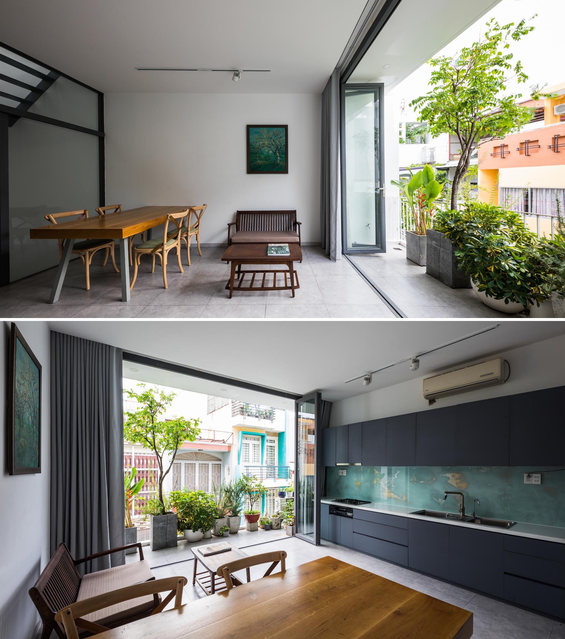 The second floor of this home includes the dining room, living room, and kitchen, all of which enjoy a balcony, where even more plants can be found.