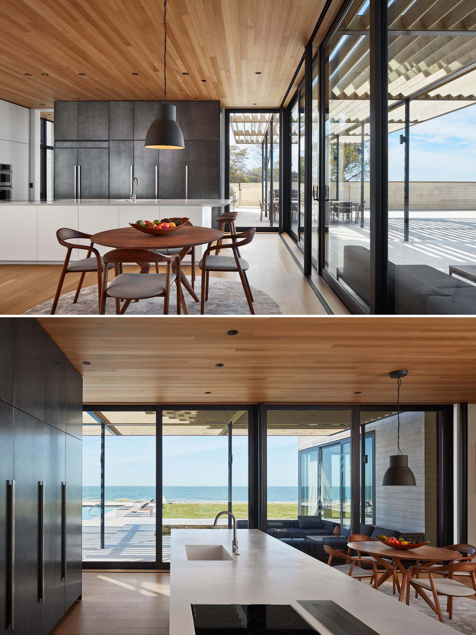 White oak flooring connects the various areas of this modern home, while in the kitchen, a long white island contrasts the gun metal cabinets.