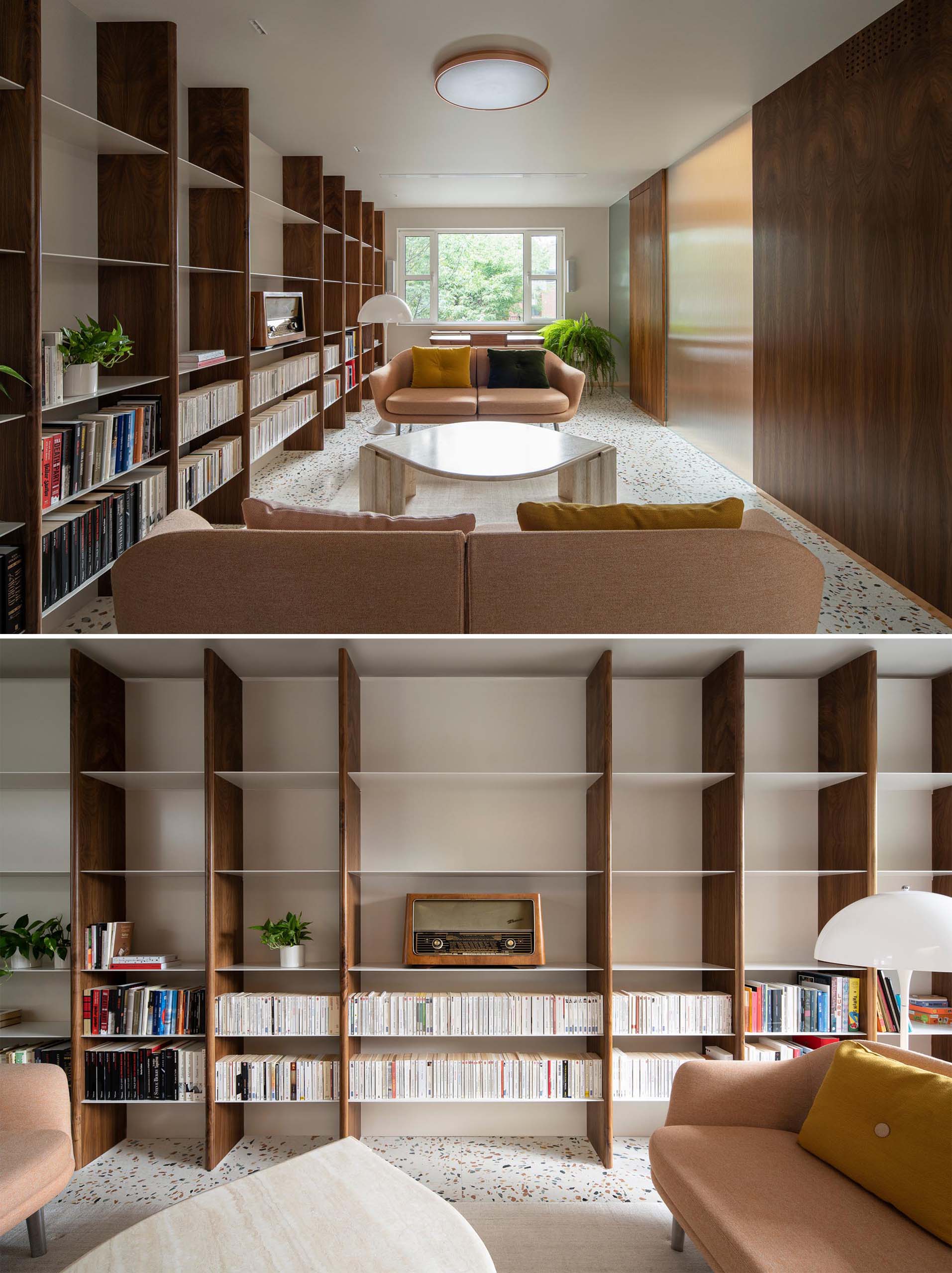 This modern living room with a terrazzo tiled floor, receives plenty of natural light, while a custom wood and metal shelving unit covers the entire wall and expands through to a secondary seating area with a colorful rug and record player.