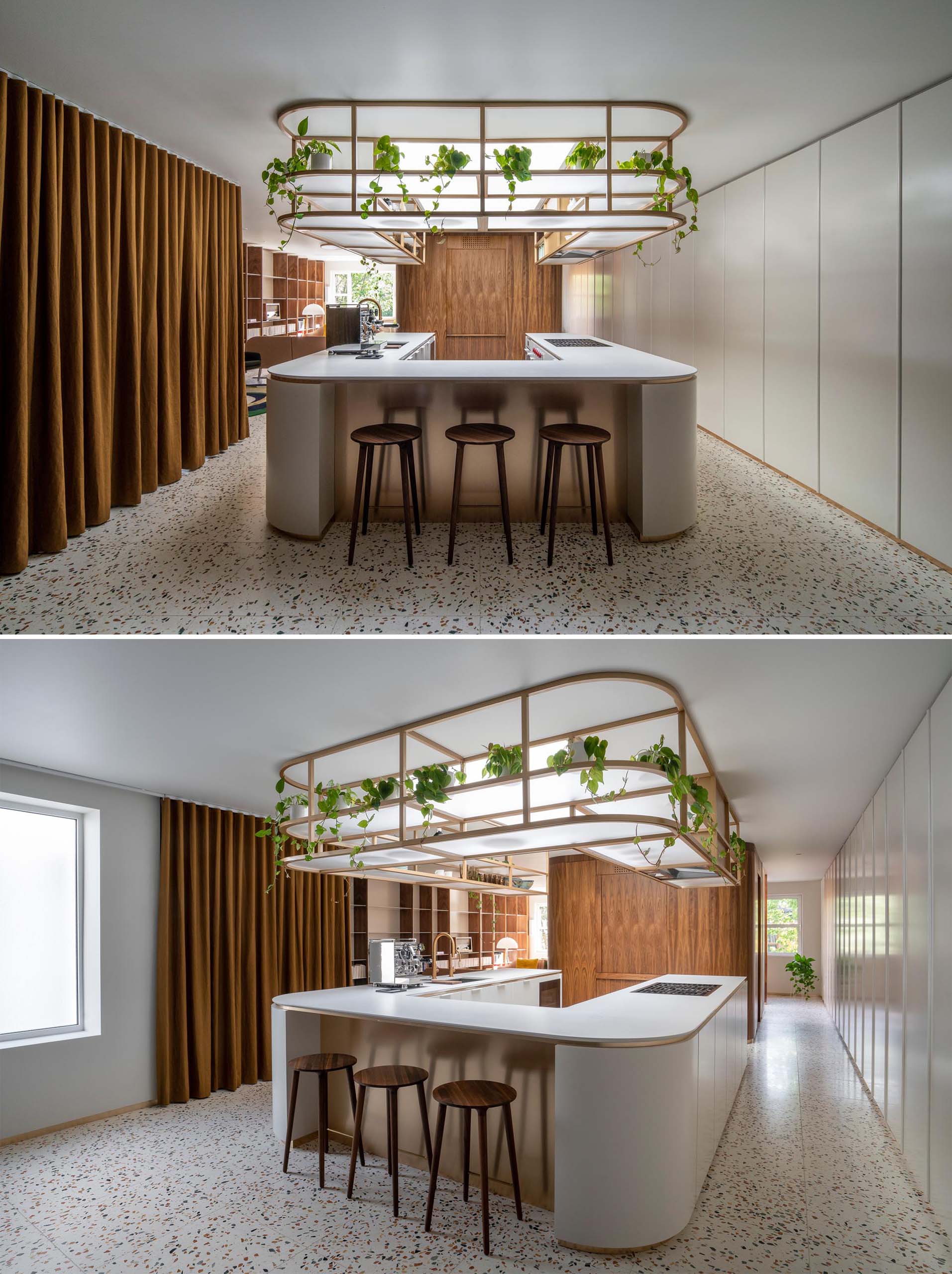 This modern U-shaped kitchen has a terrazzo tile floor, and an elegantly curved countertop with matching upper shelves that are open for easy access.