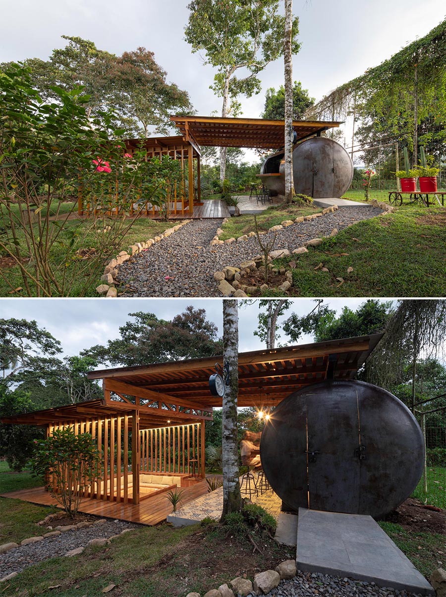 A covered outdoor entertaining space with a bar located within a repurposed water tank, and a sunken conversation pit.