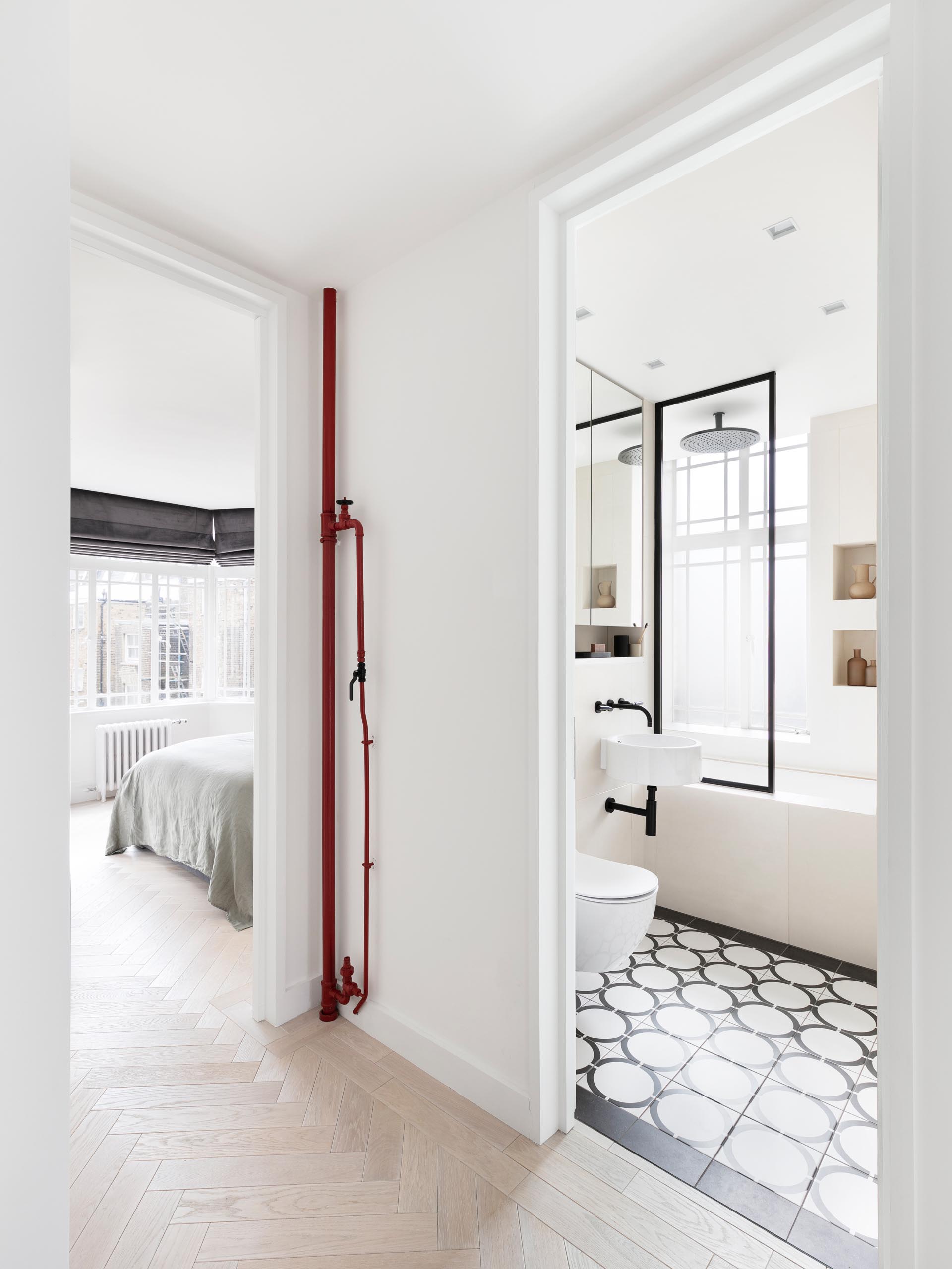 Space saving pocket doors have been installed throughout this modern apartment, like for the bedrooms and bathroom.