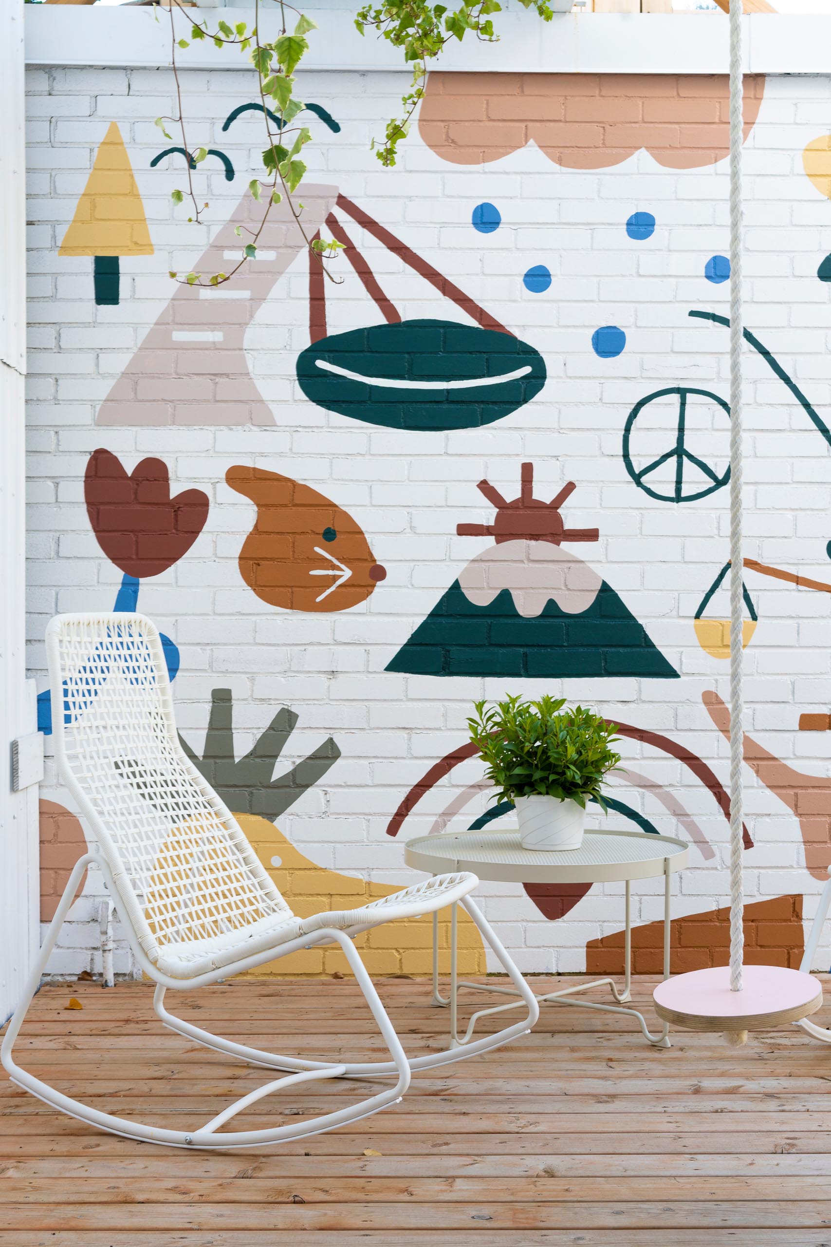 A modern and private courtyard with a fun and colorful mural by artist Marc-Olivier Lamothe.