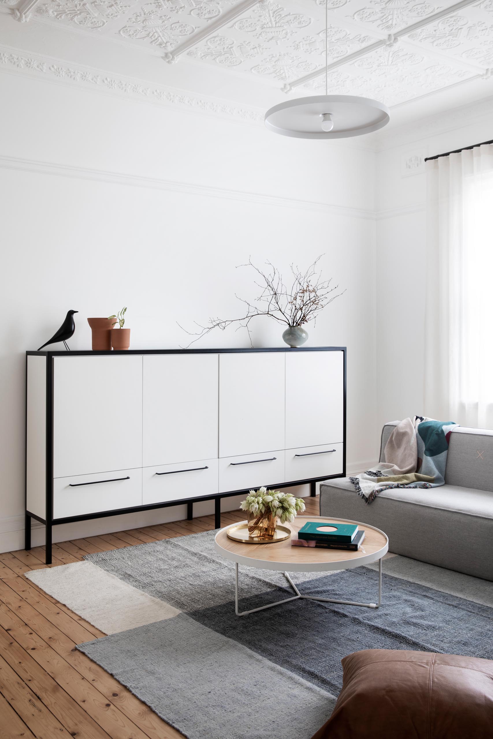 An updated living room that retains original elements like an ornate
pressed-tin ceiling and cast-iron fireplace.