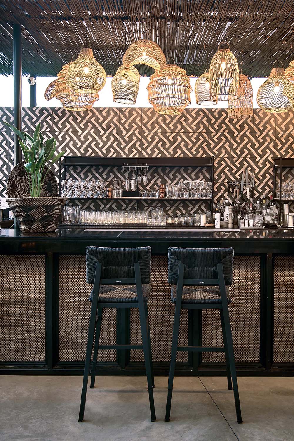 This restaurant and bar has a beach aesthetic that was created with reed screens, lighting, and decor.