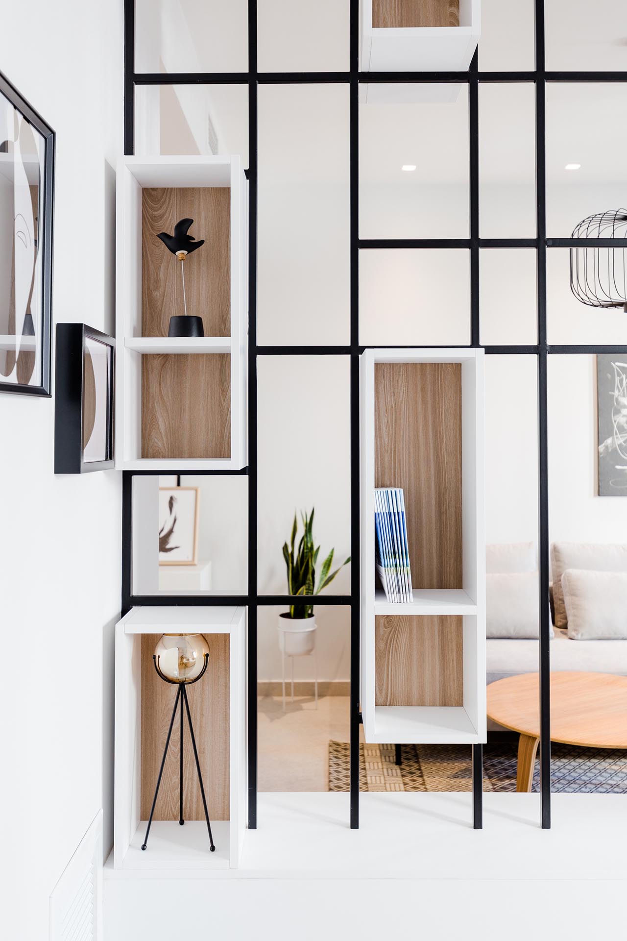 A modern room divider with built-in shelving.