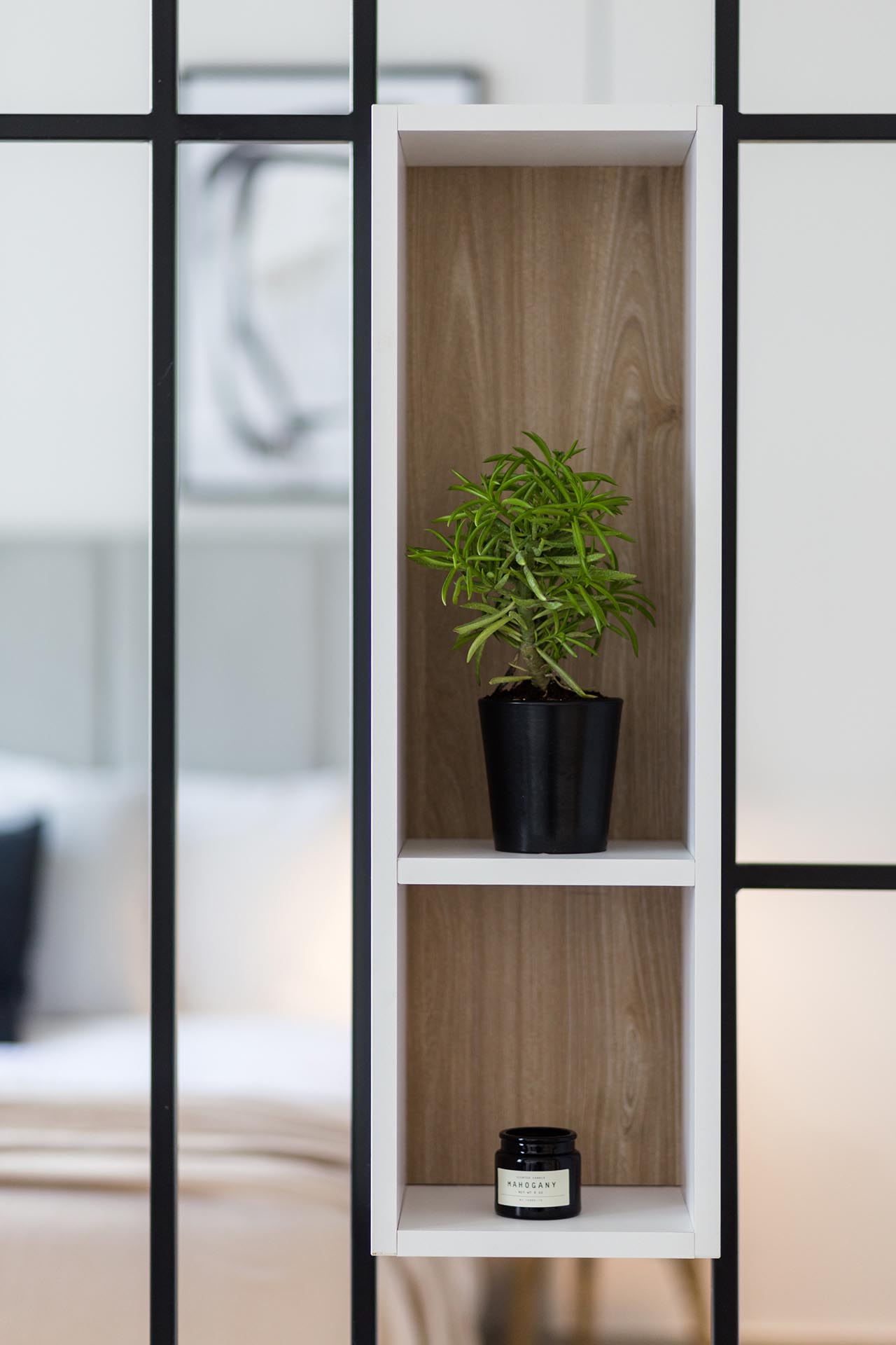 A modern room divider with built-in shelving.