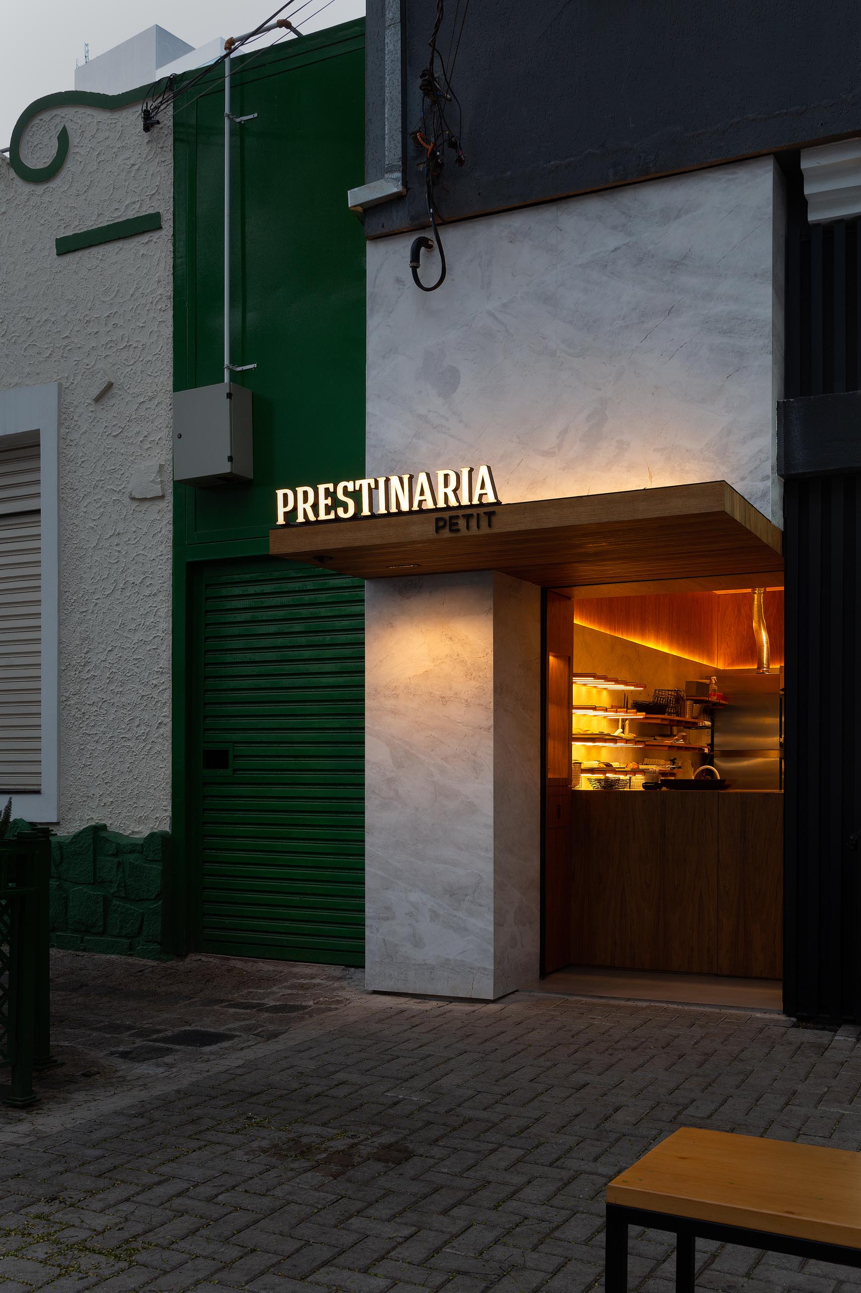 A small bakery makes use of wood dowels with hidden LED lighting to hold up shelving.