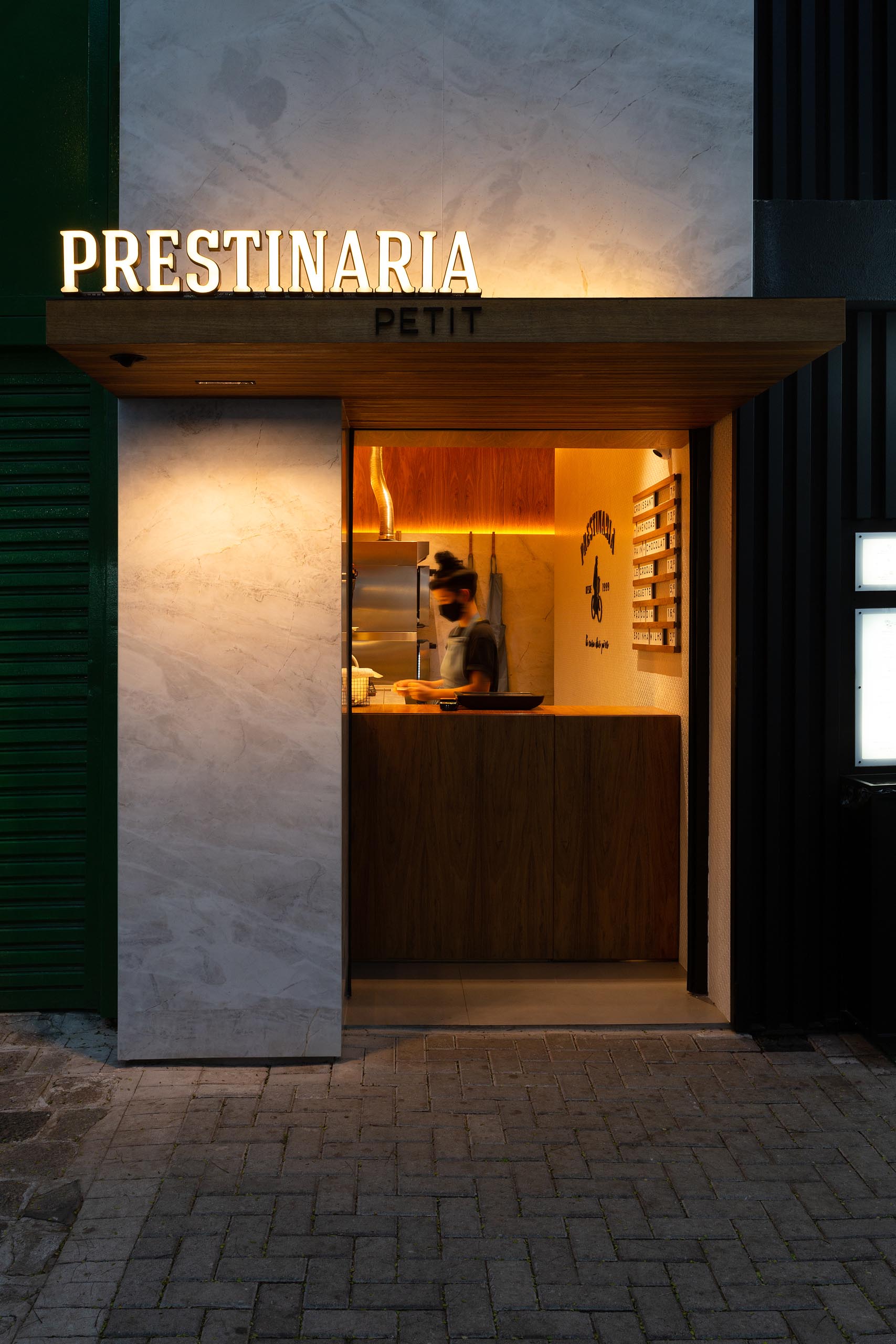 A small bakery makes use of wood dowels with hidden LED lighting to hold up shelving.