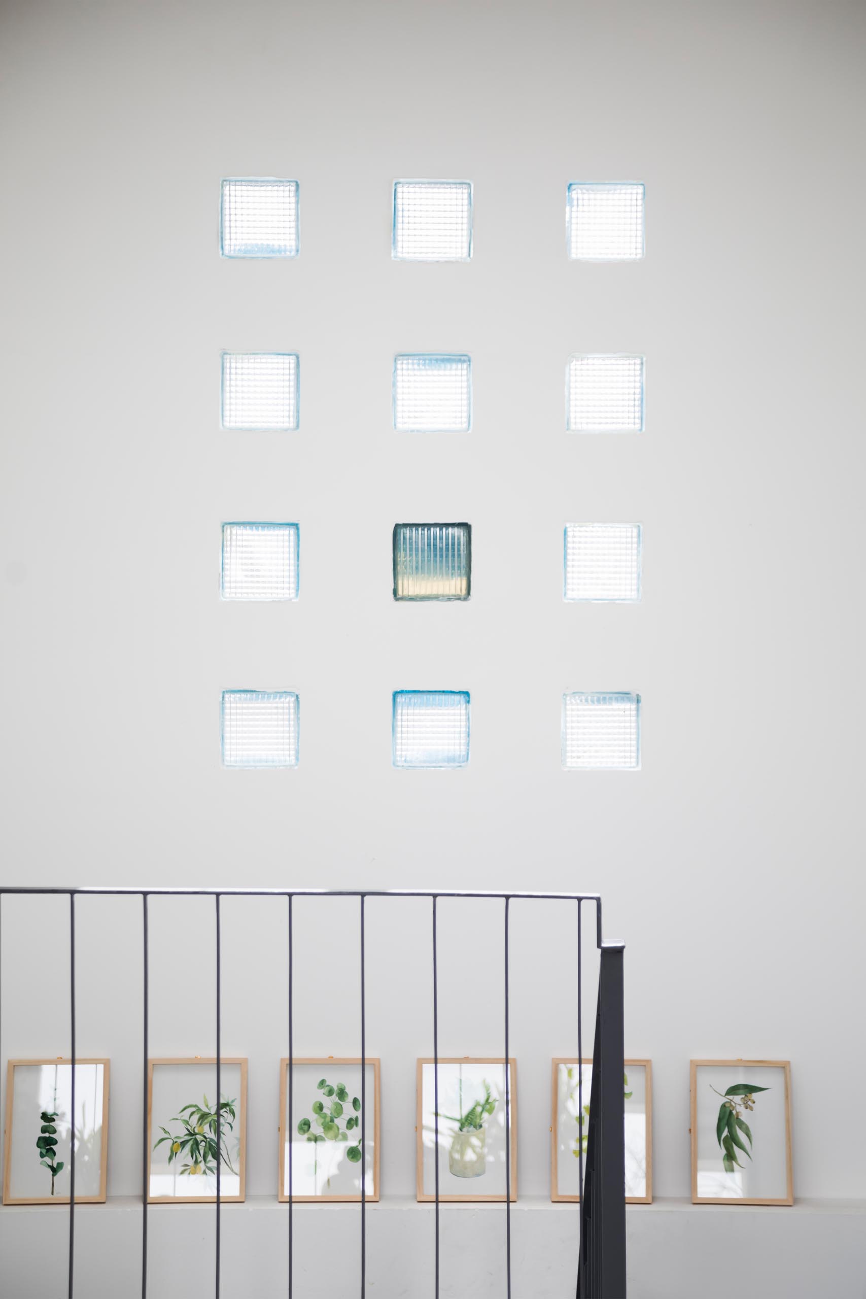 A wall with a grid of small glass block windows.