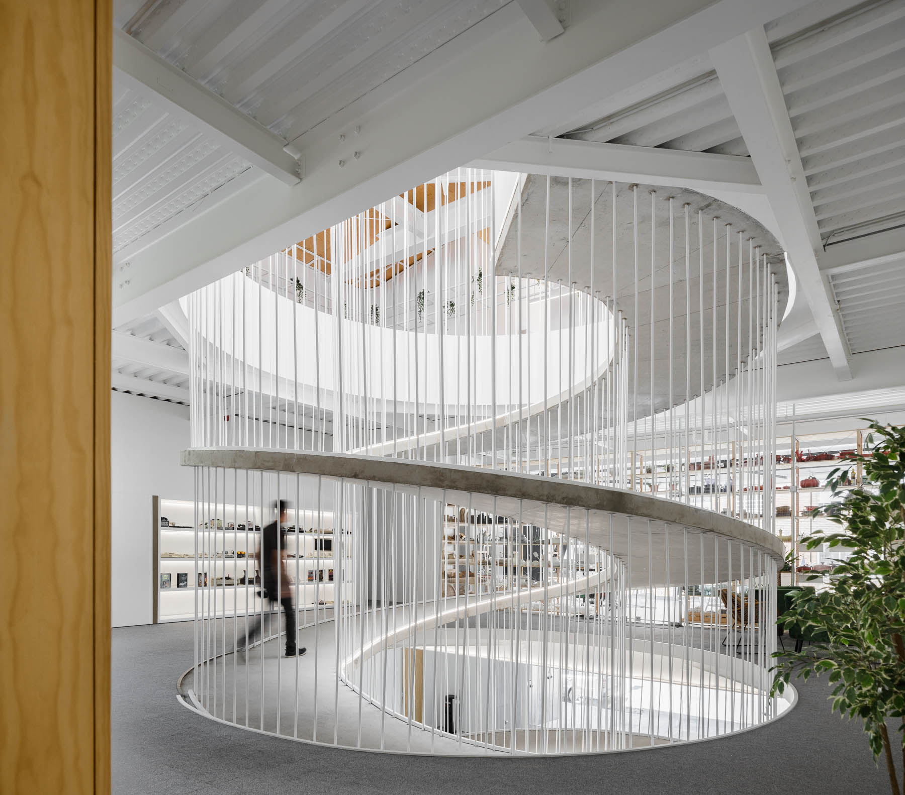 A spiraling ramp replaces the need for stairs in this modern office and adds a sculptural element.