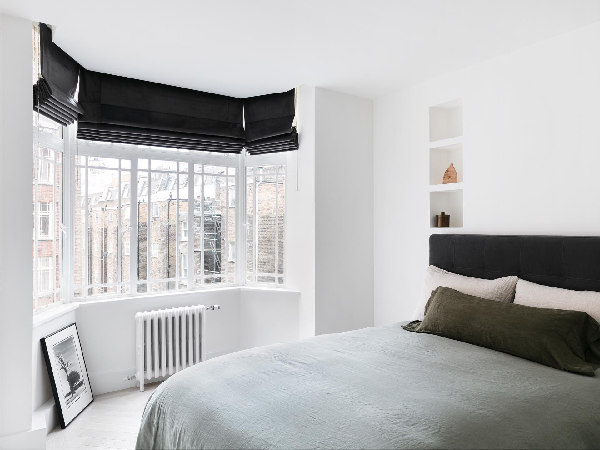 In this remodeled bedroom, the designers opened-up hidden wall niches and lowered the ceilings to hide curtain tracks.