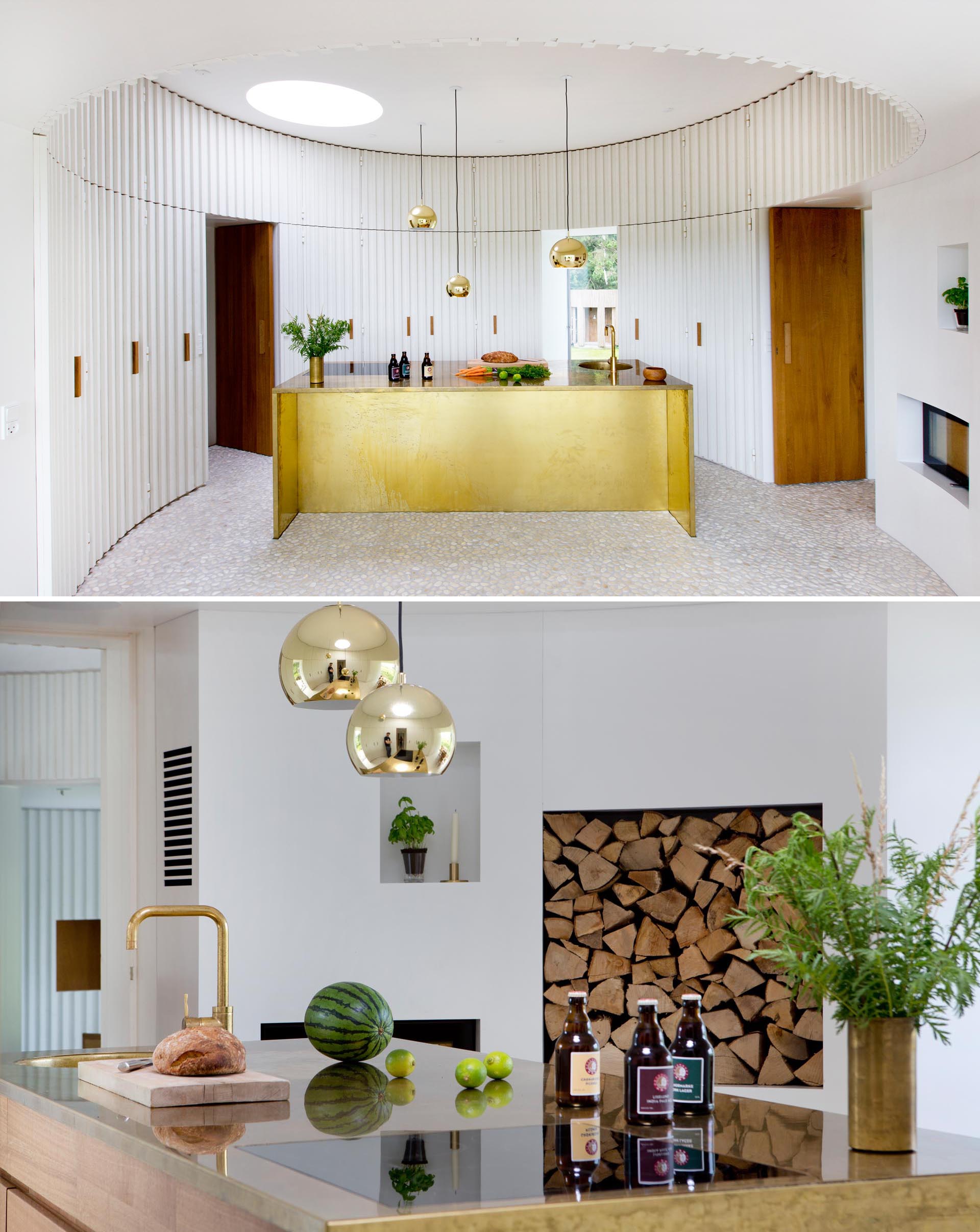 This modern kitchen has river pebble floors, while the kitchen island adds a luxurious metallic accent.