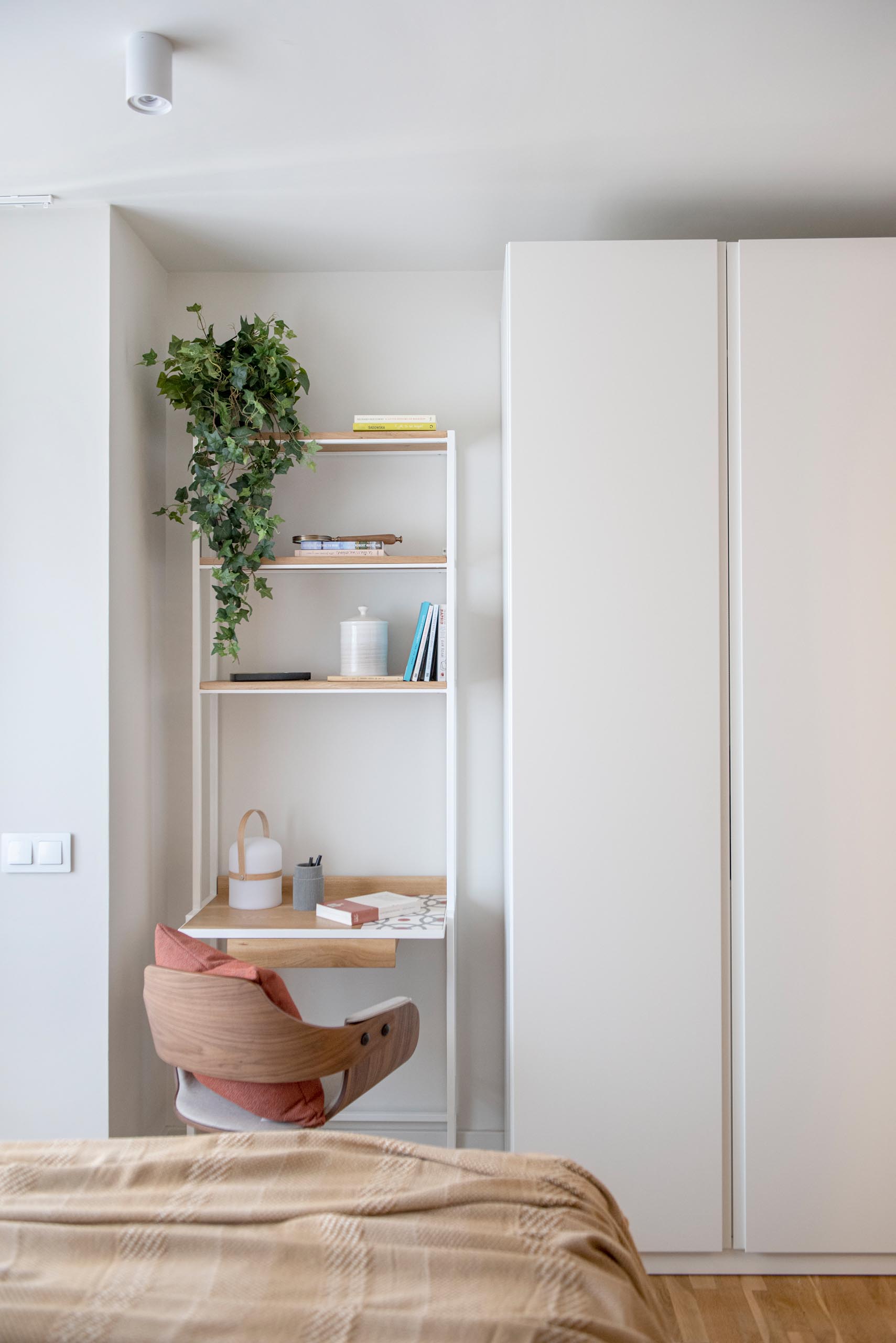 A modern bedroom with a small desk area.