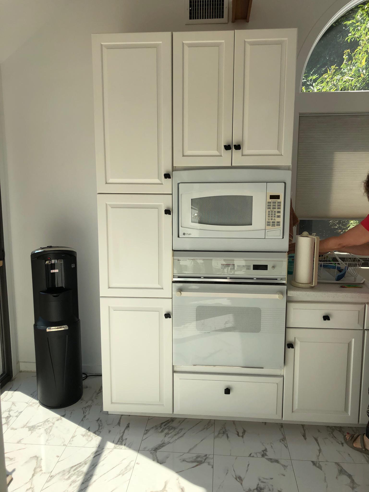 This original 1980s kitchen was outdated with old appliances and an uniquely shaped island. It was remodeled and transformed into a contemporary kitchen.