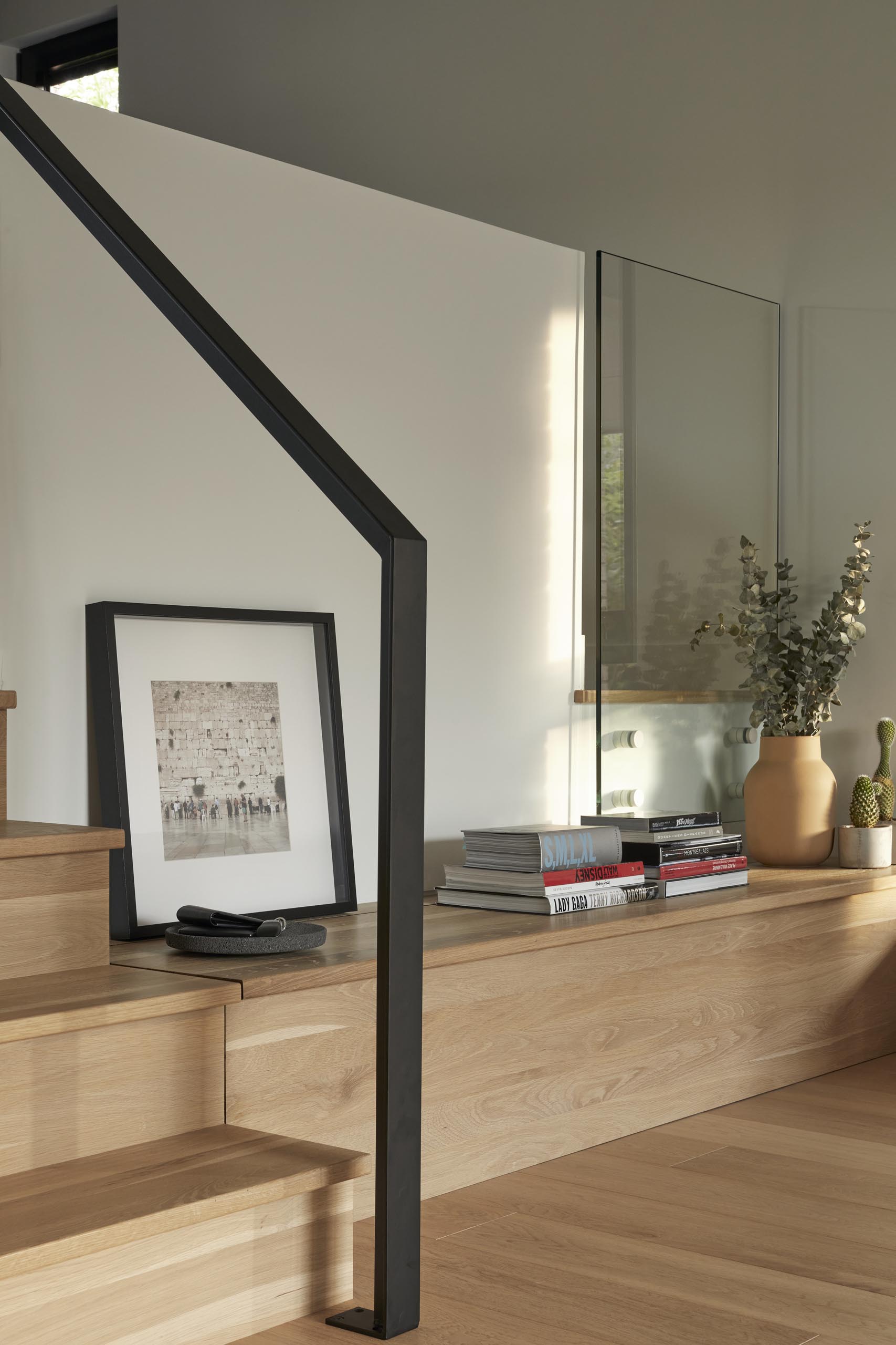 Steps that extend to include a bench made of white oak, lead from the living room to the dining room and kitchen.