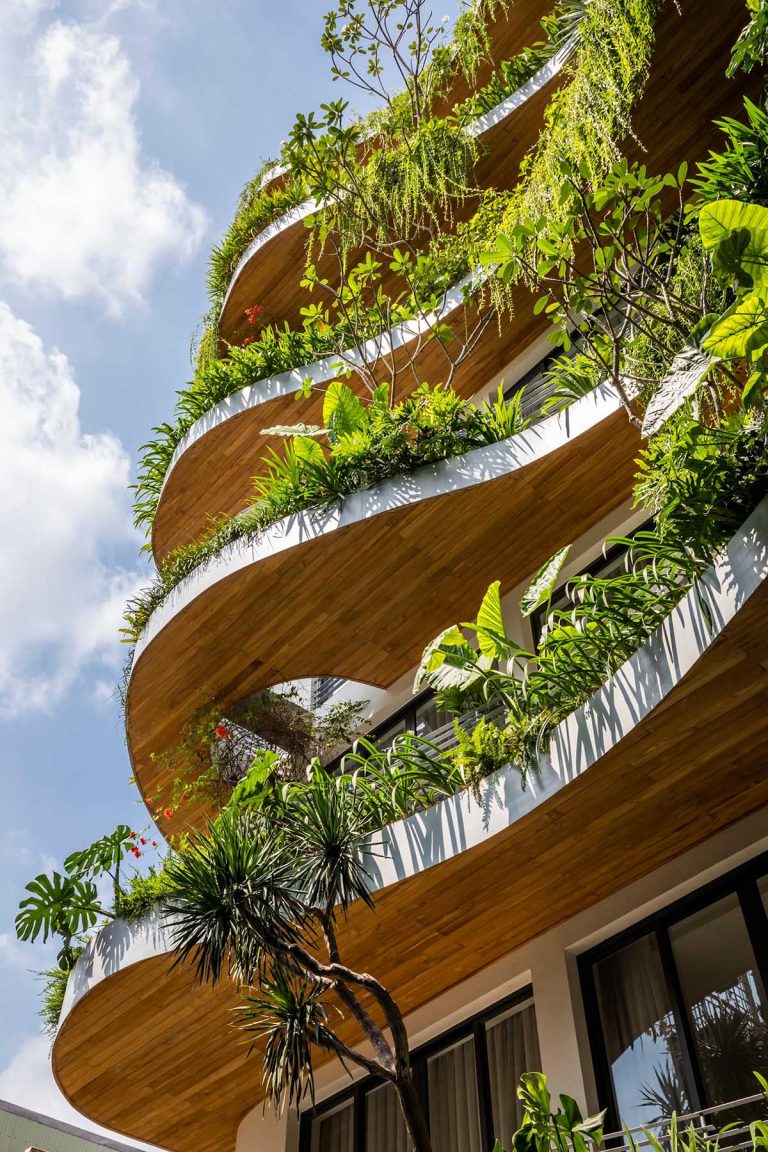 Wavy Balconies With Overhanging Plants Are A Design Feature On This